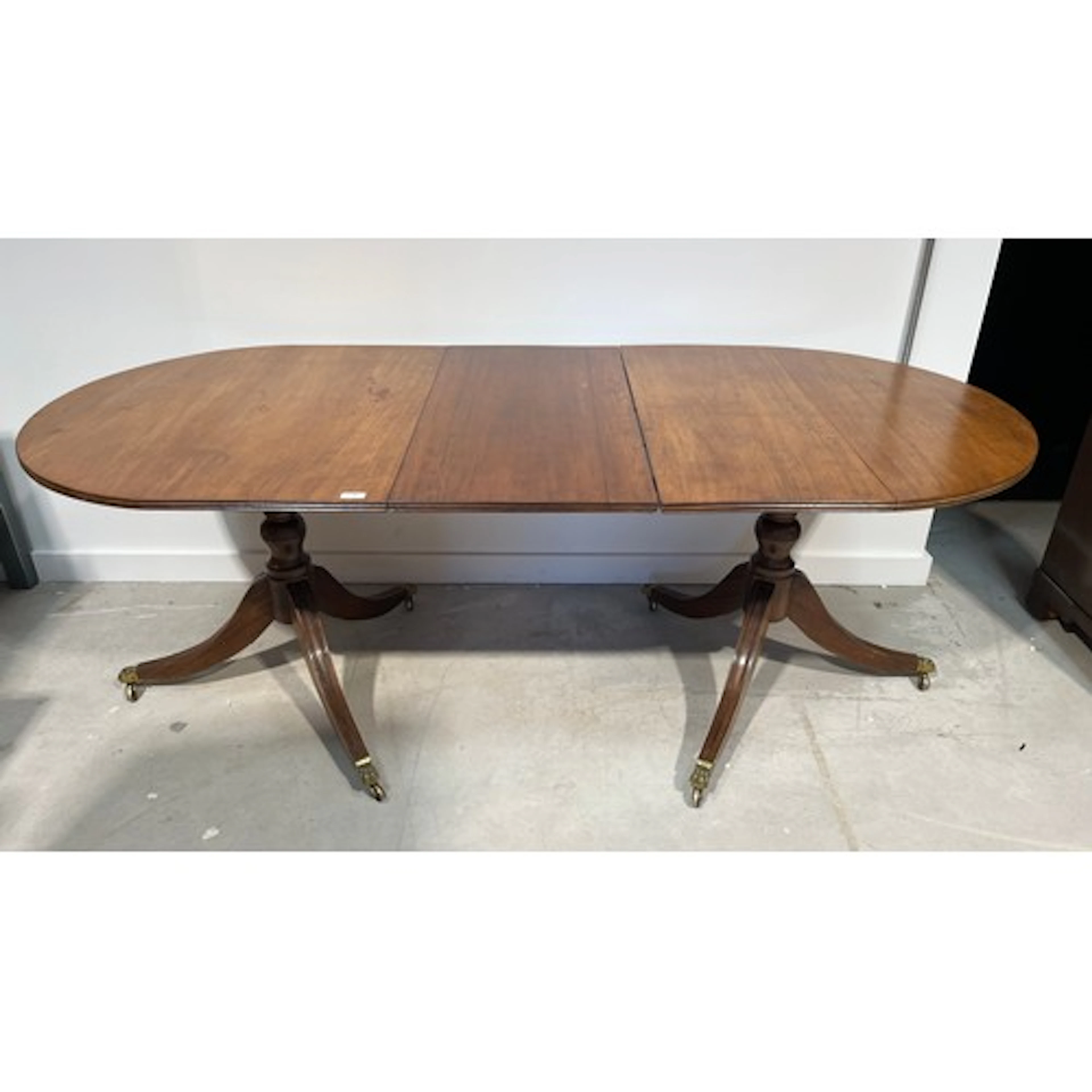 Regency style mahogany twin pedestal extending dining table,...