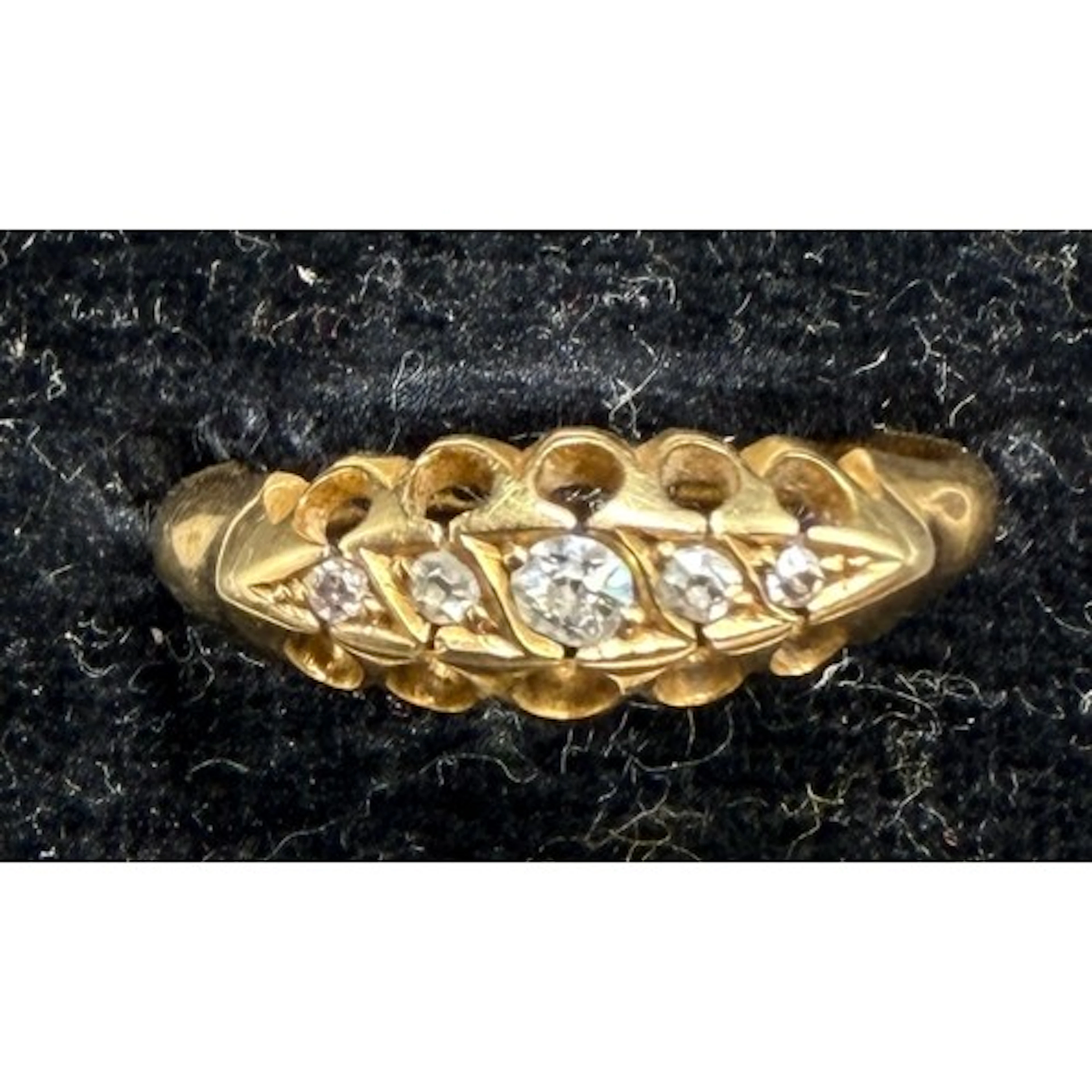 A yellow metal ring set with 5 diamonds. Size J. Weight 2.4g...