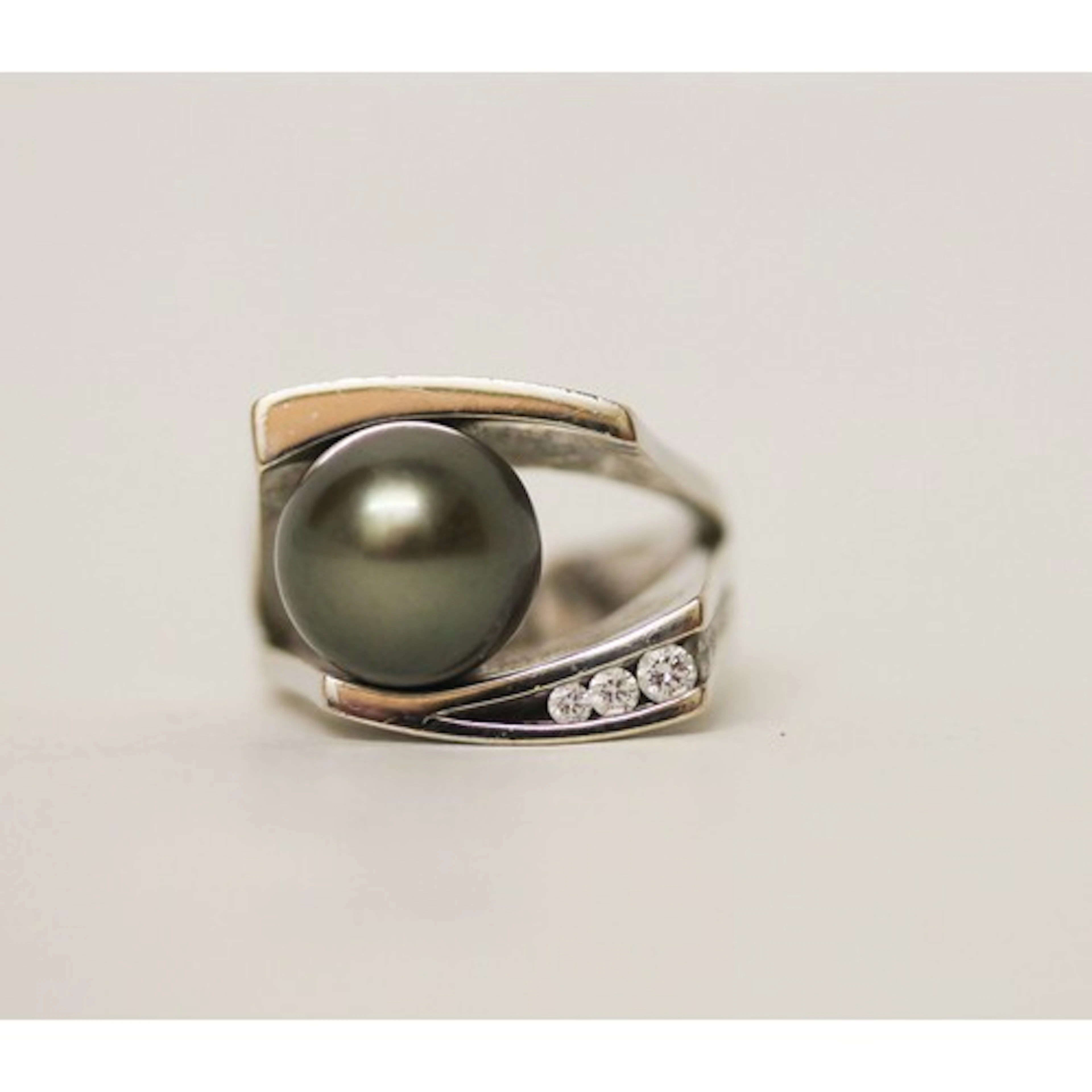 A modern black pearl and diamond statement dress ring, in 18...