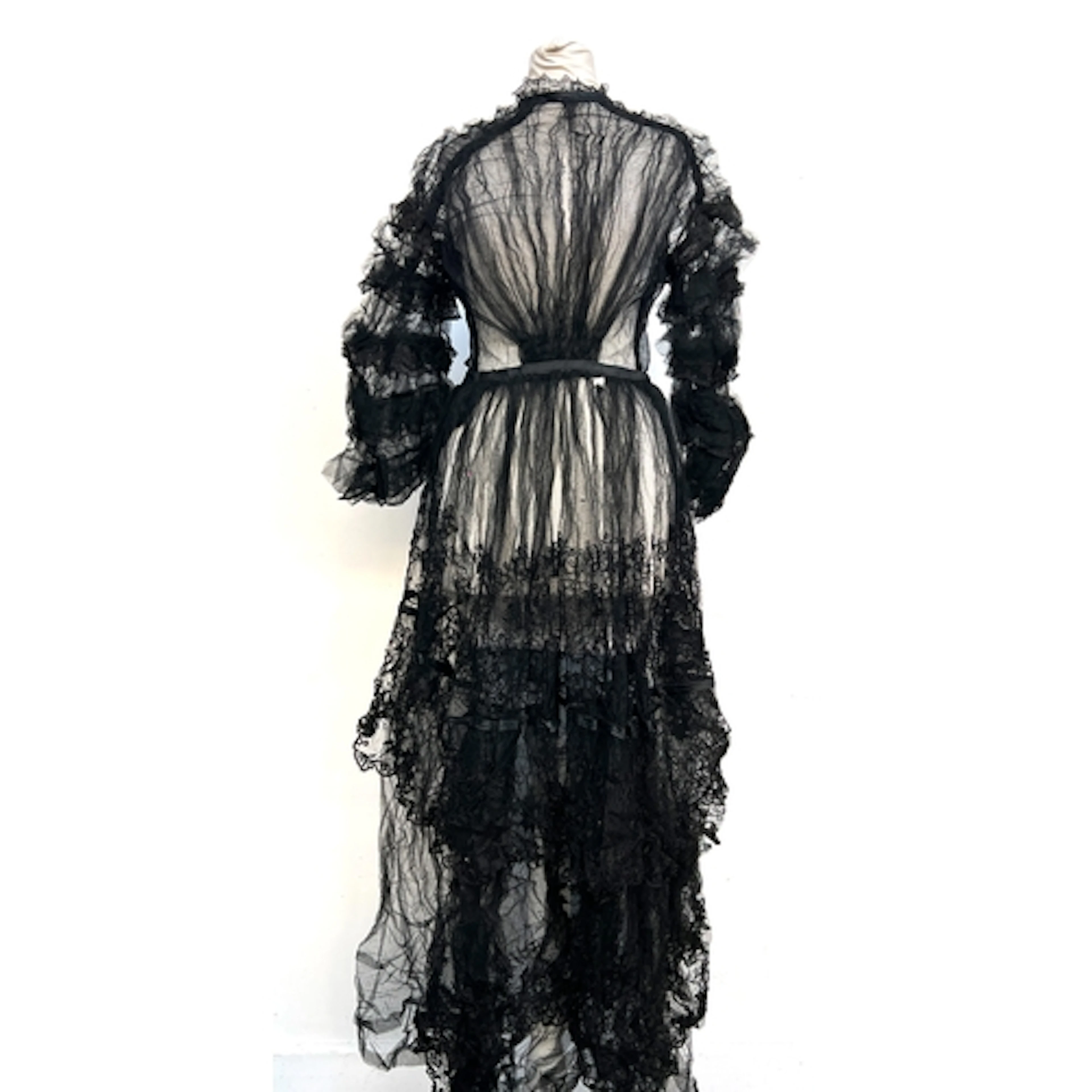 A late 19th/early 20th century black lace long sleeved dress...