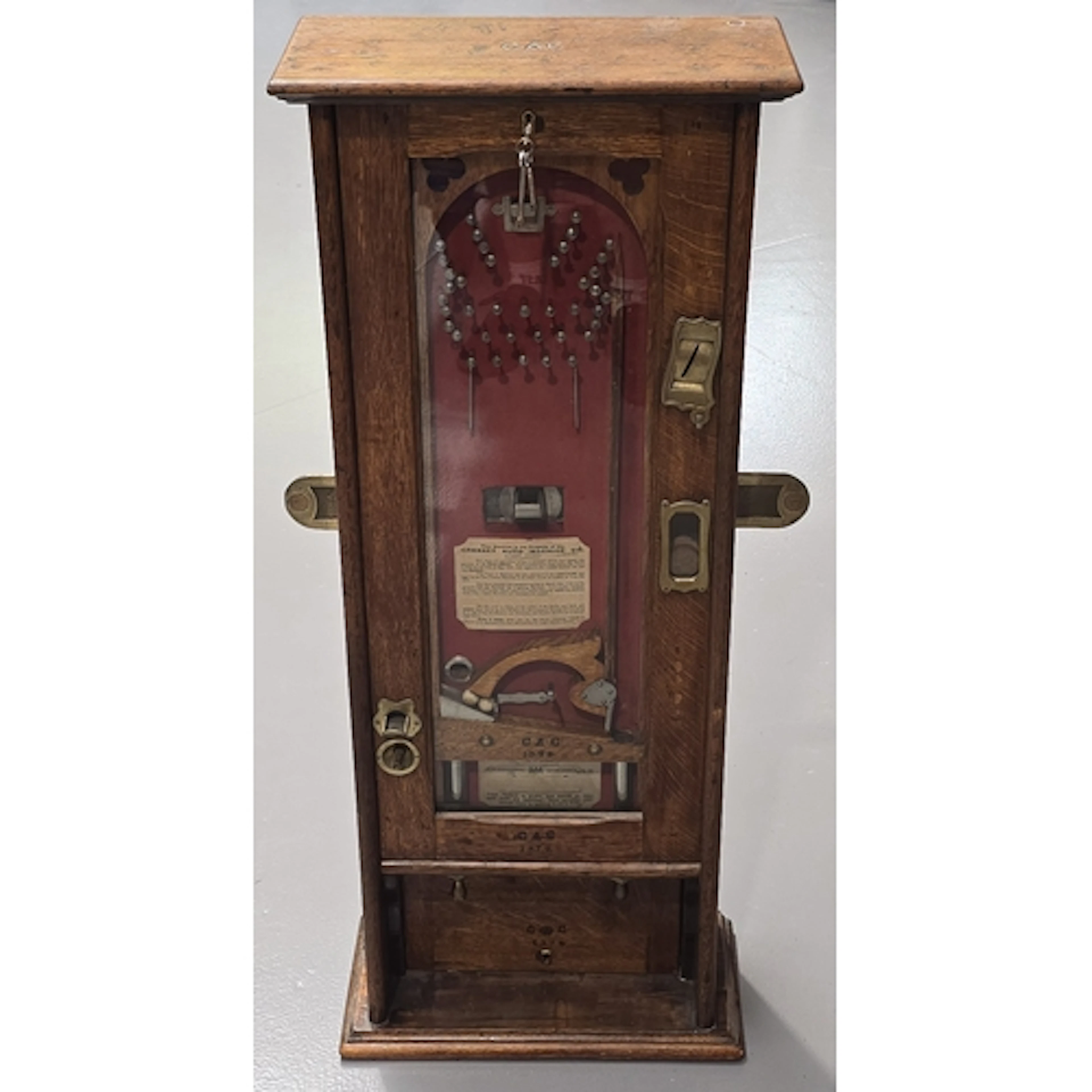 An antique "The Cresset" penny-in-the-slot wall Bagatelle Ma...