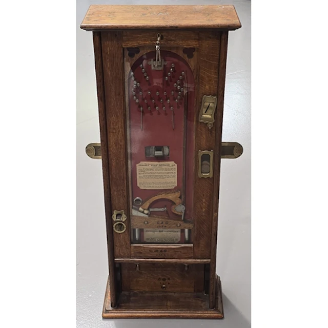 An antique "The Cresset" penny-in-the-slot wall Bagatelle Ma...