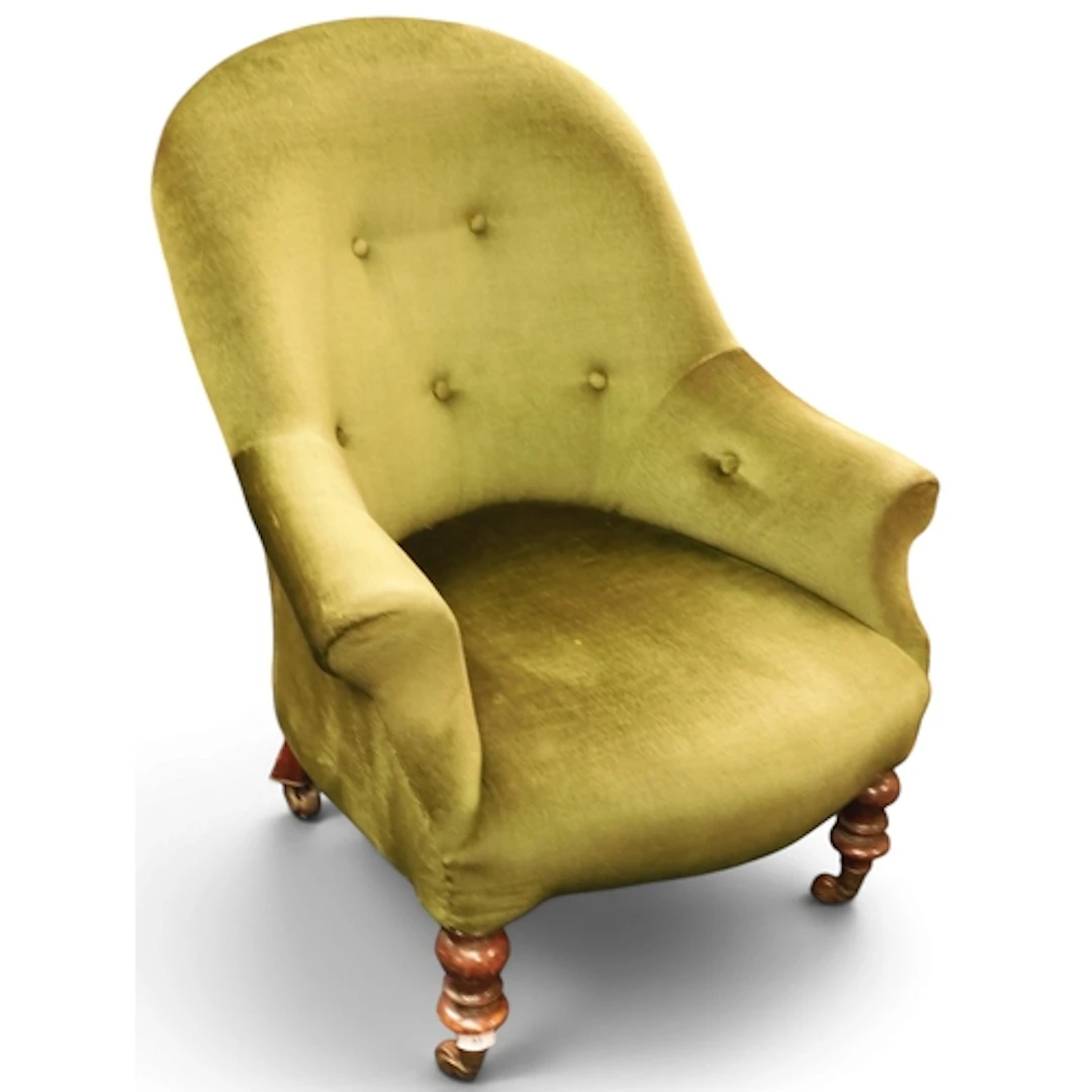 A Victorian green velour upholstered lounge armchair on turn...