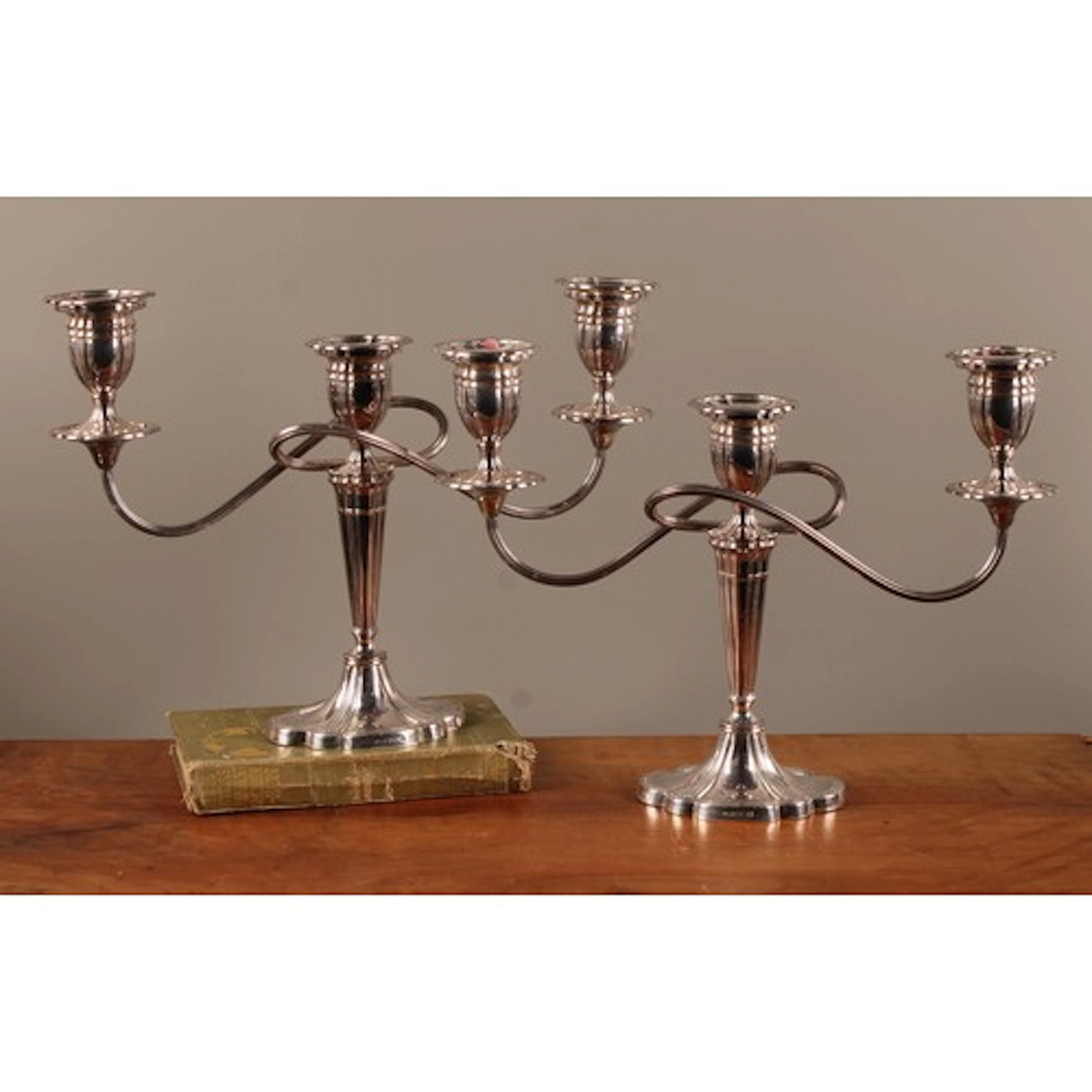 A pair of Queen Elizabeth II silver two branch table candles...