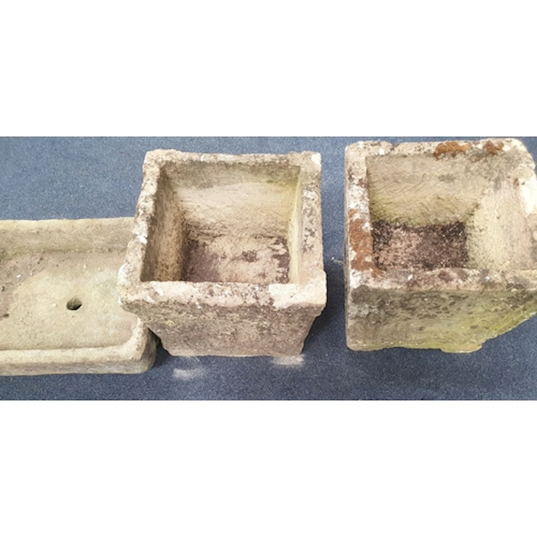 THREE LARGE STONE GARDEN PLANTERS two of square design, one...