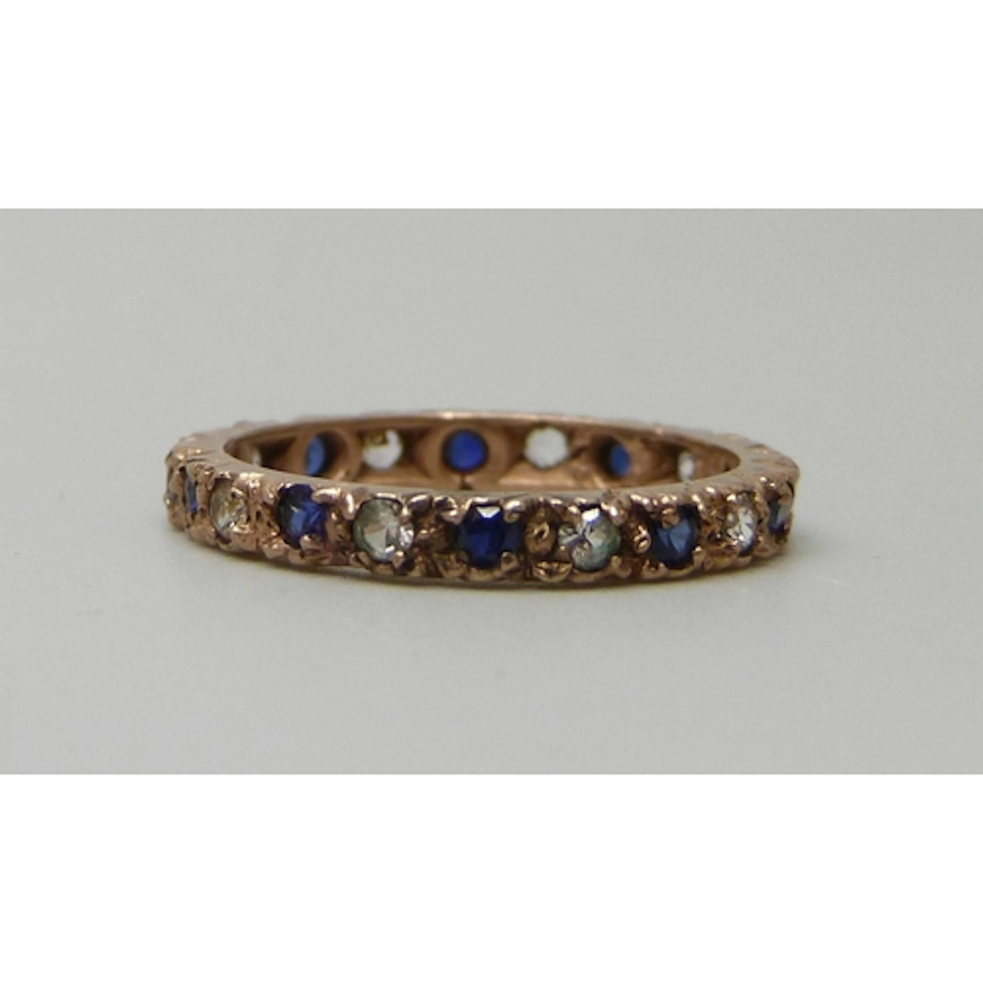 A 9ct gold, sapphire and white stone eternity ring, 2.2g, O