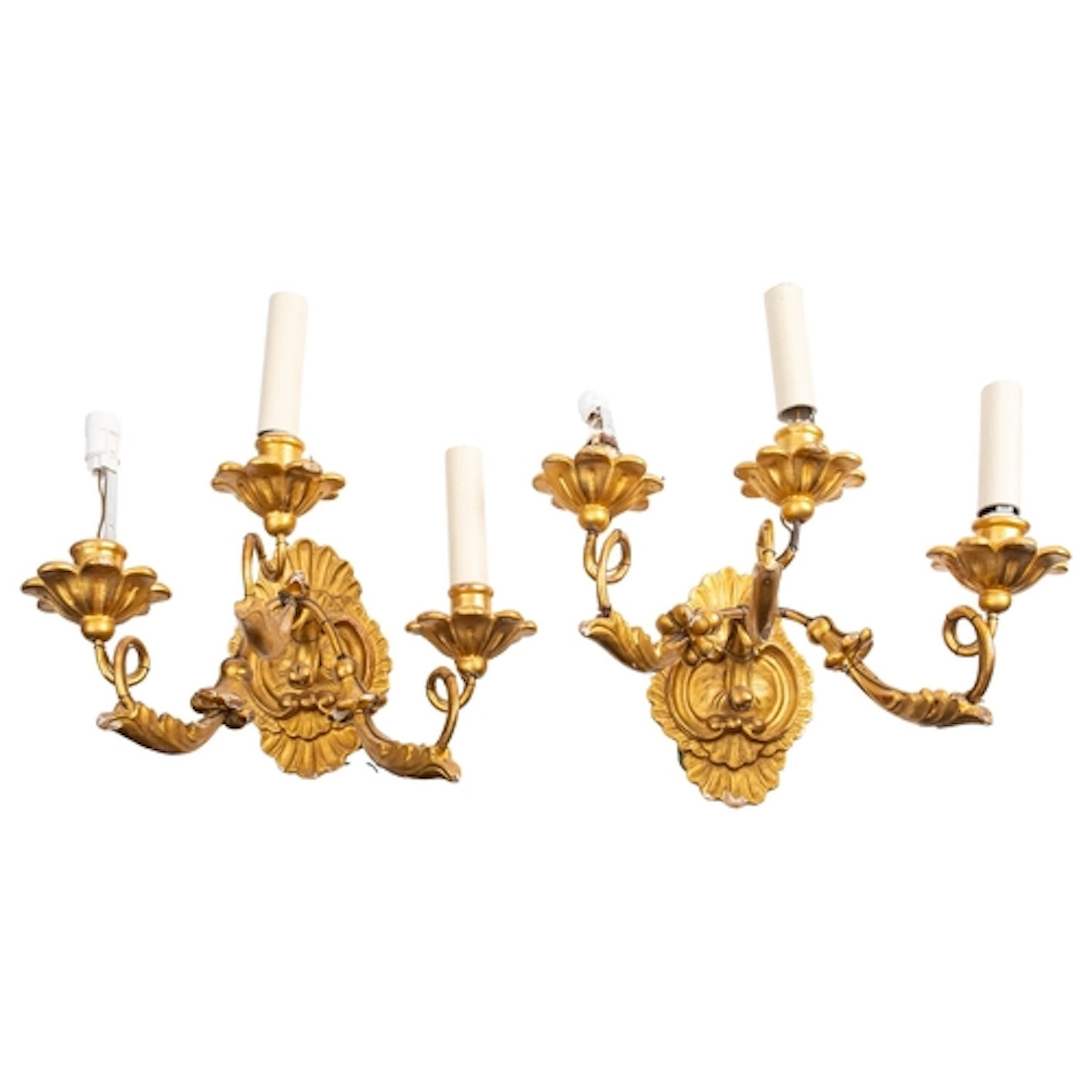 A pair of carved and giltwood three-light wall appliques, in...