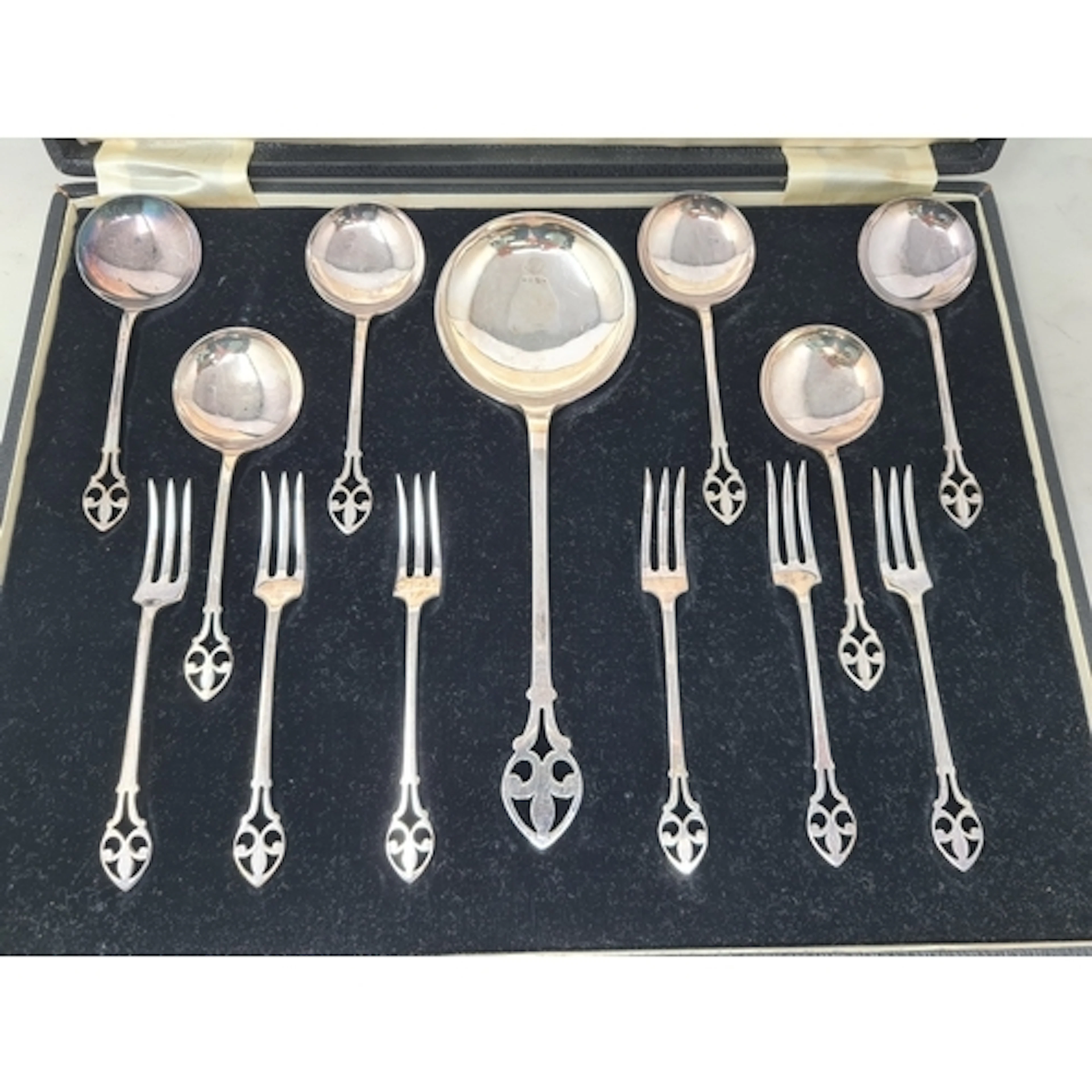 A plated Tea Time Set with six forks and dessert spoons and ...