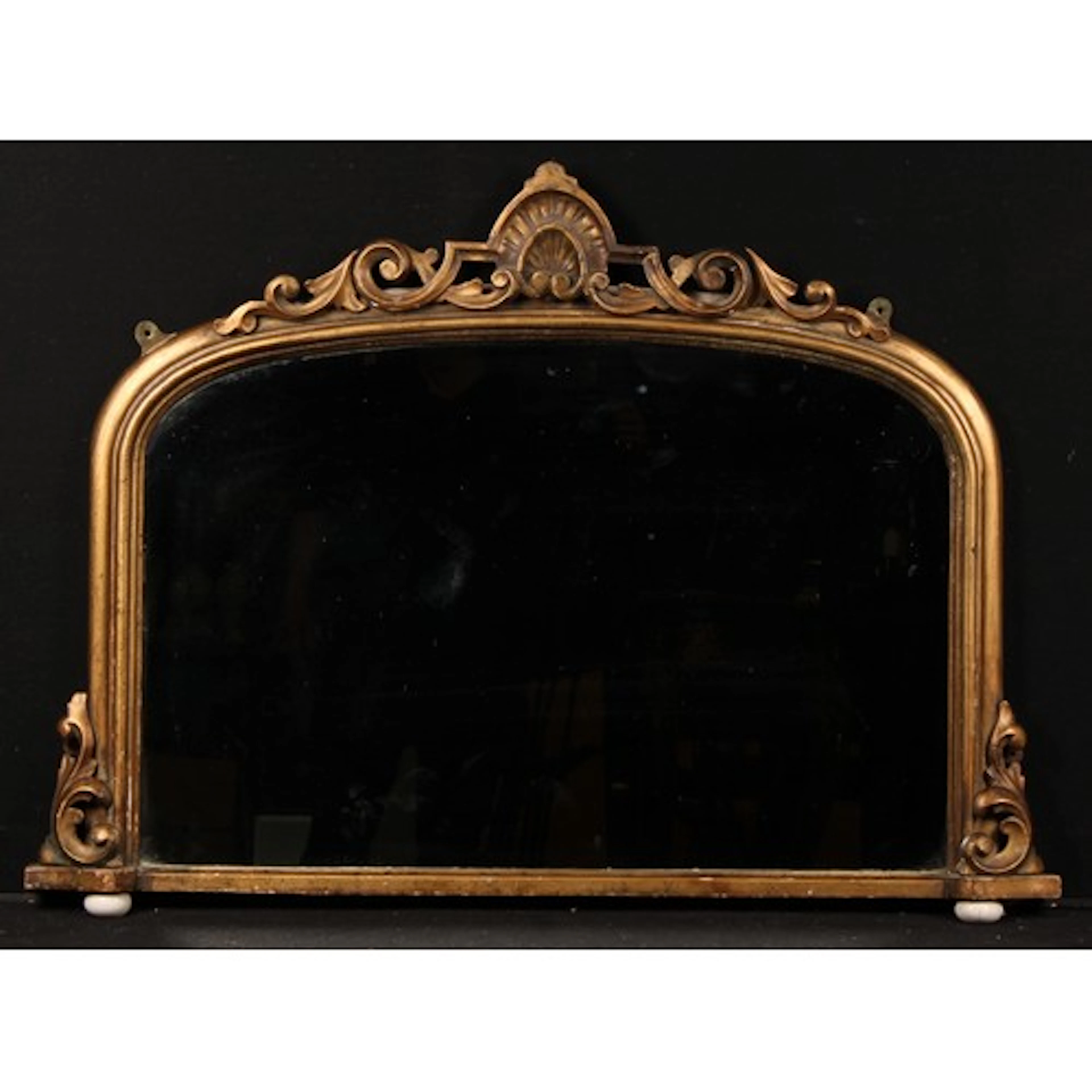 A Victorian giltwood and gesso chimney glass, arched mirror ...