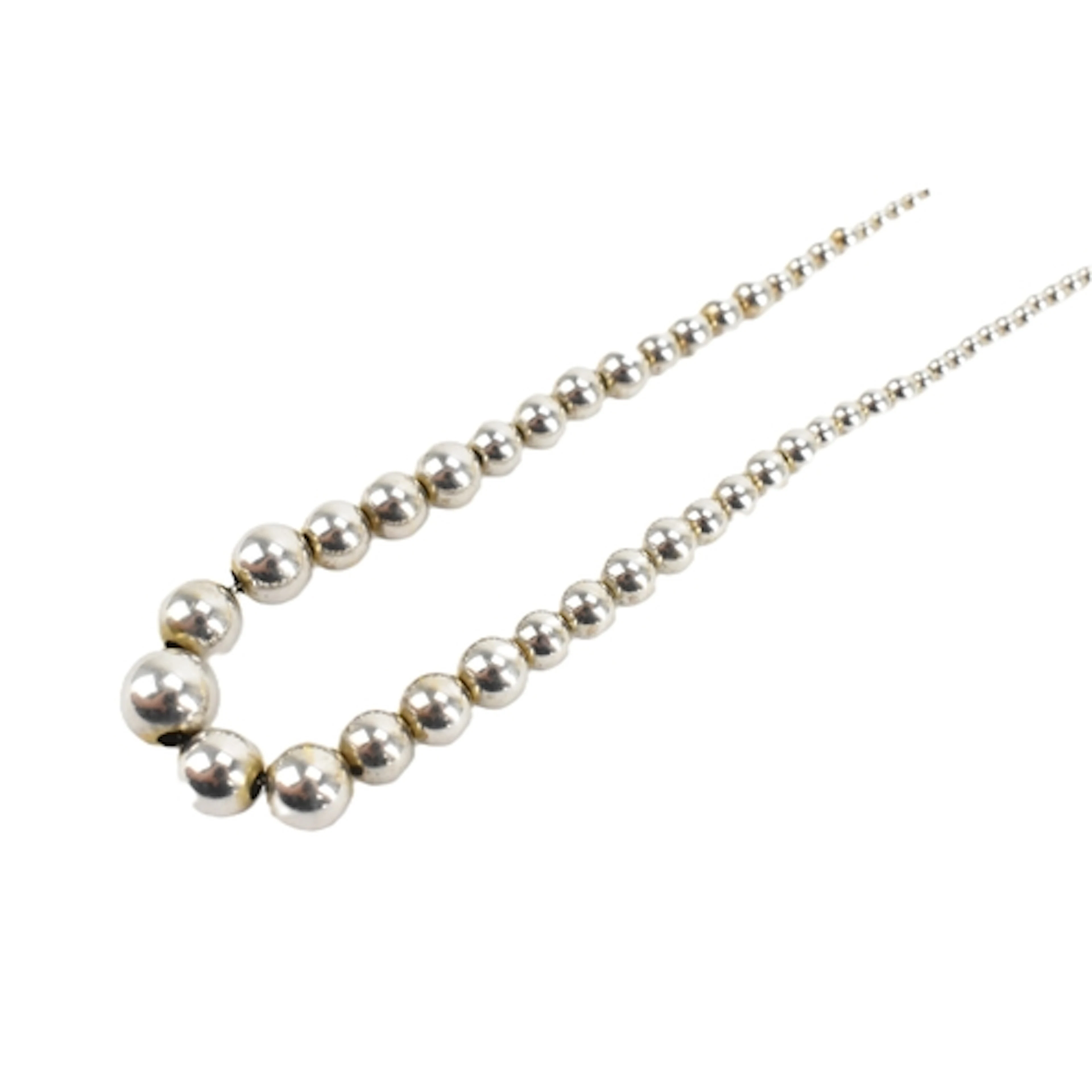 An 18ct white gold necklace, formed as graduating beads conn...