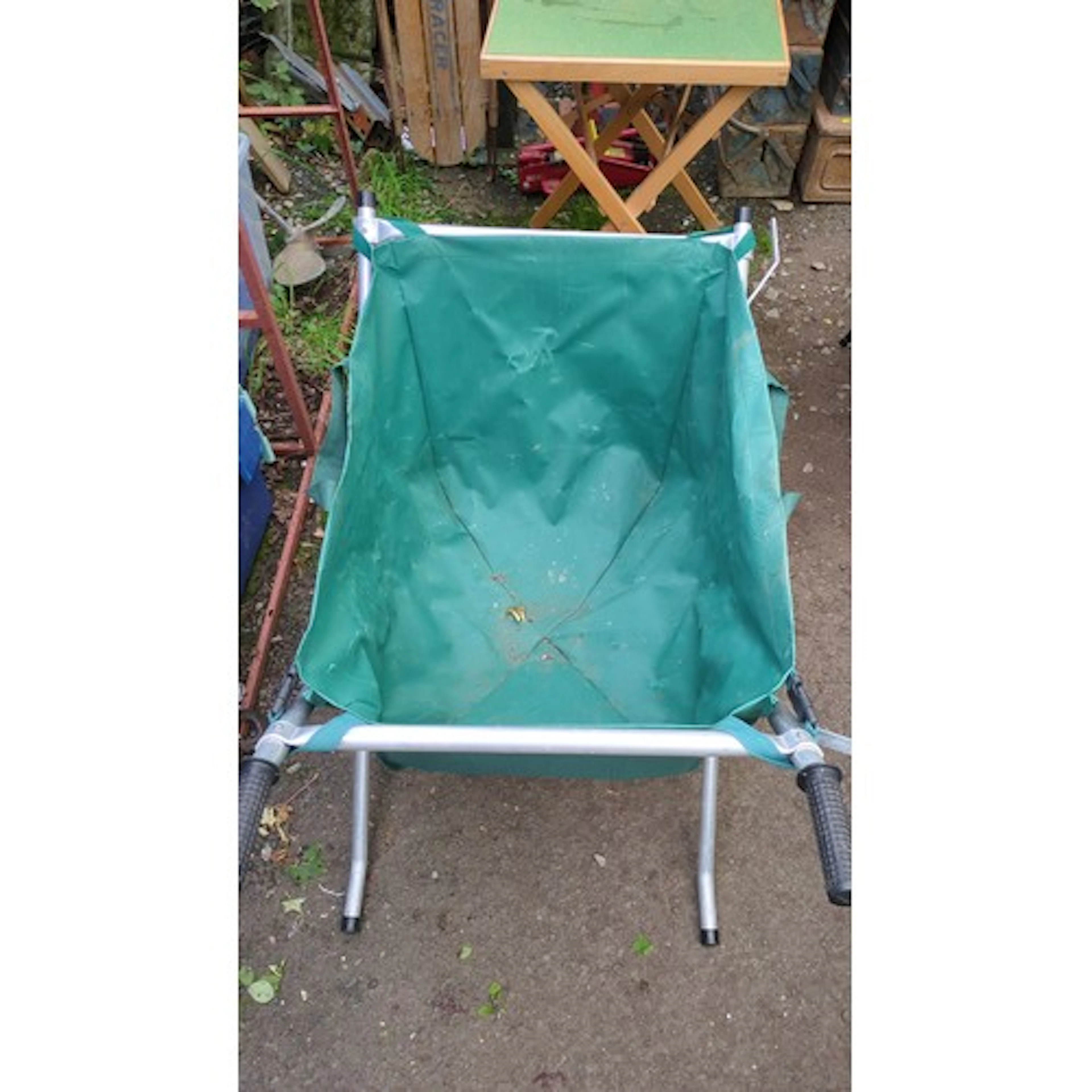 Folding garden barrow with green canvas hopper, on an alumin...