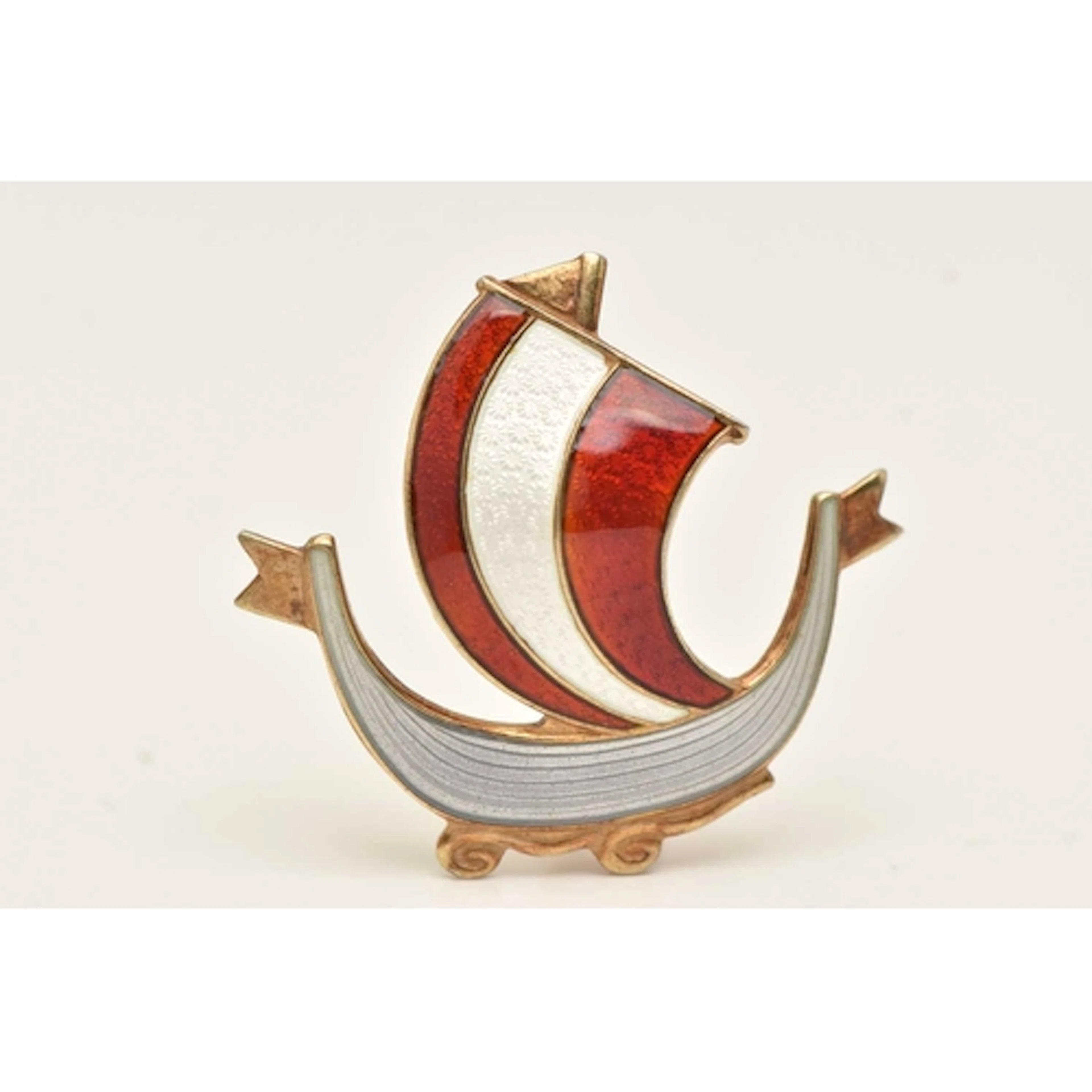A NORWEGIAN GILT METAL AND ENAMEL SHIP BROOCH, decorated wit...