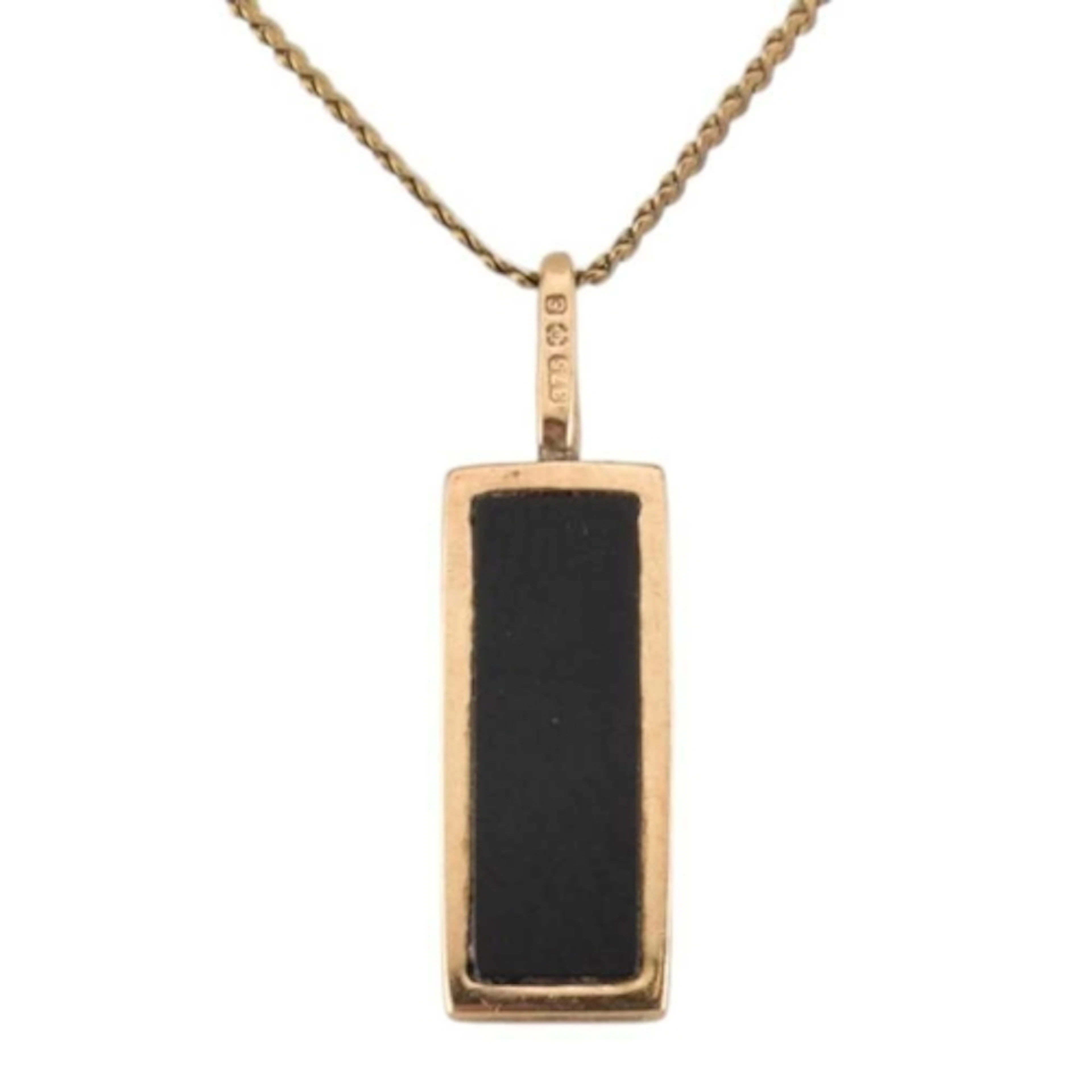 A hallmarked 9ct gold and onyx pendant necklace. Import hall...