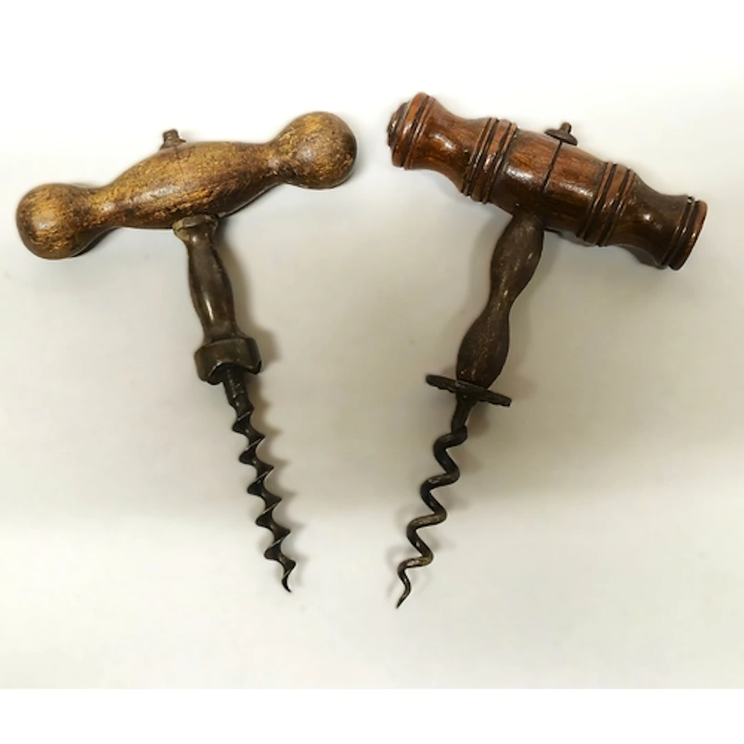 Antique pull metal corkscrew with turned wood handle, and an...