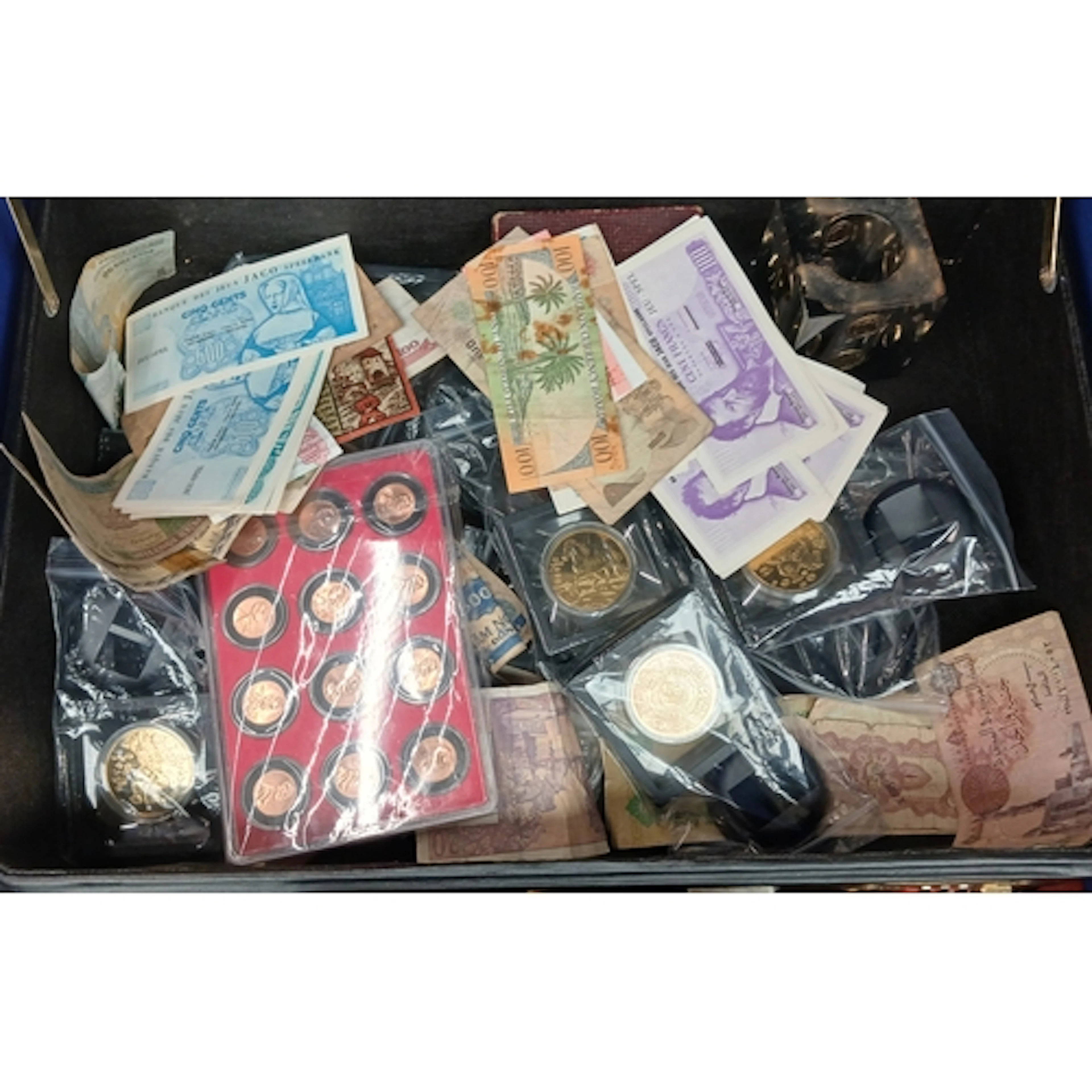 A case of assorted world coins, banknotes & accessories to i...