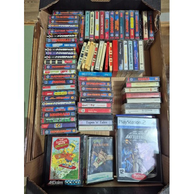 A box of assorted vintage computer games & some music casset...
