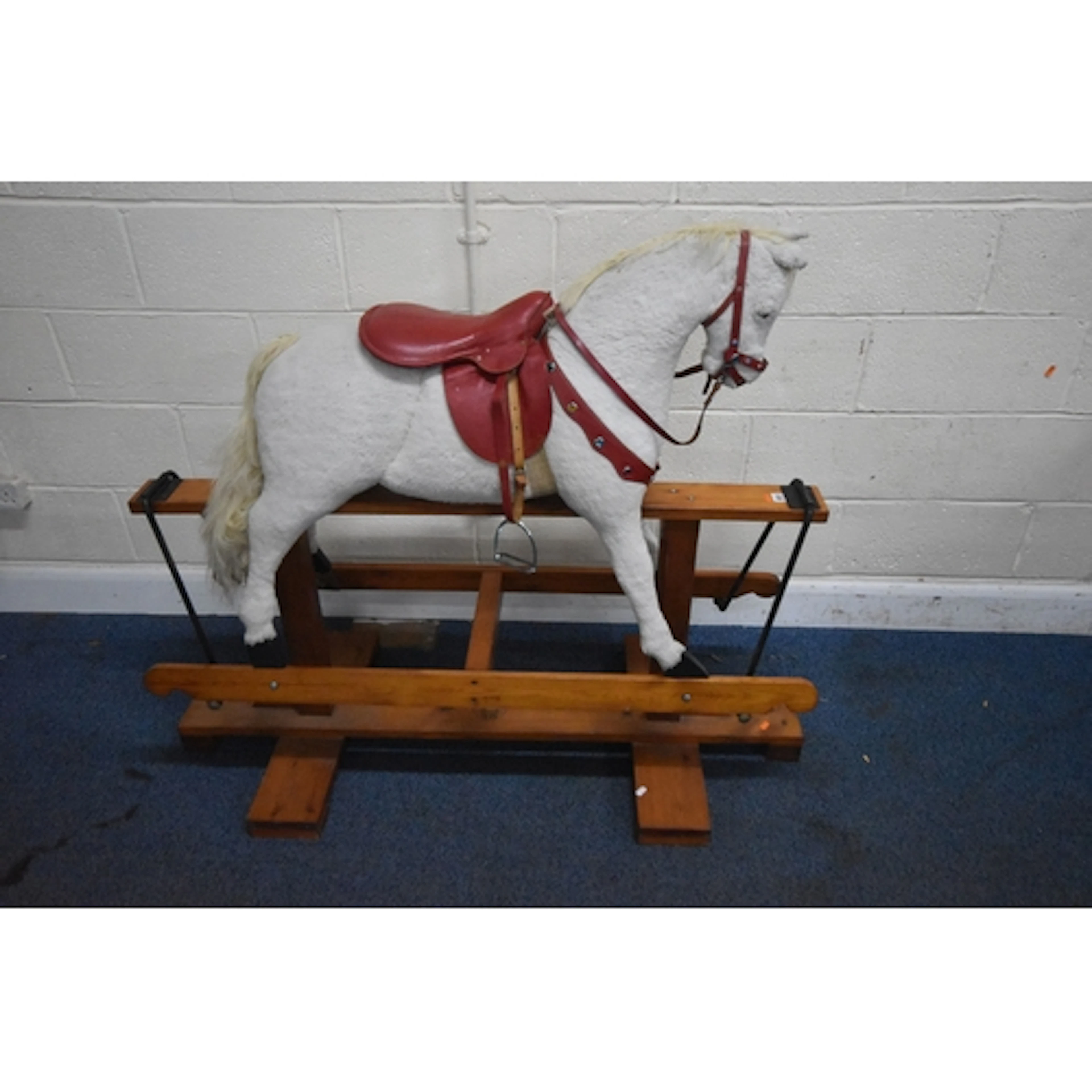 PEGASUS TOYS, A WHITE ROCKING HORSE, with a red staddle, rai...