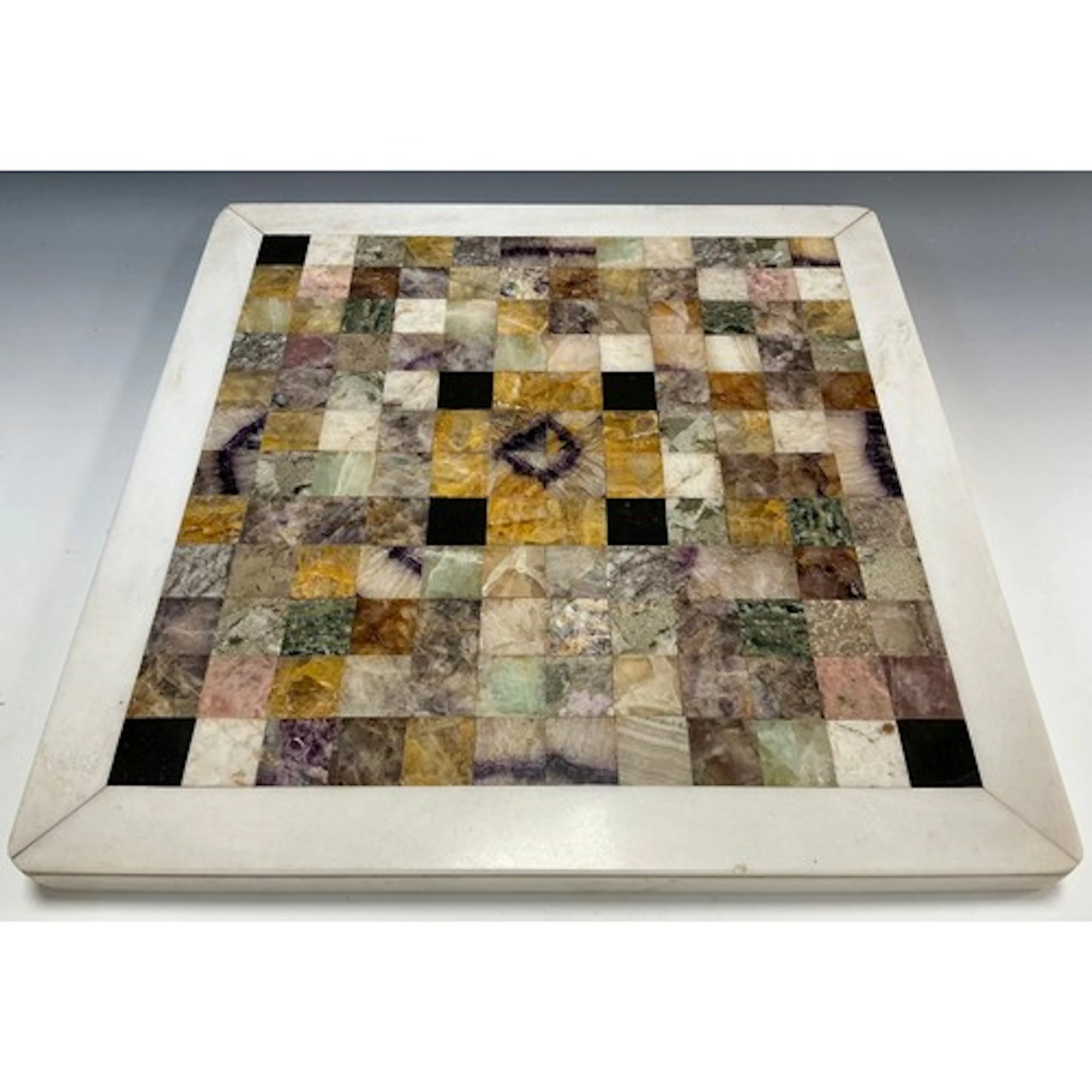 A specimen stone in set table top, the 12 x 12 cubed chequer...