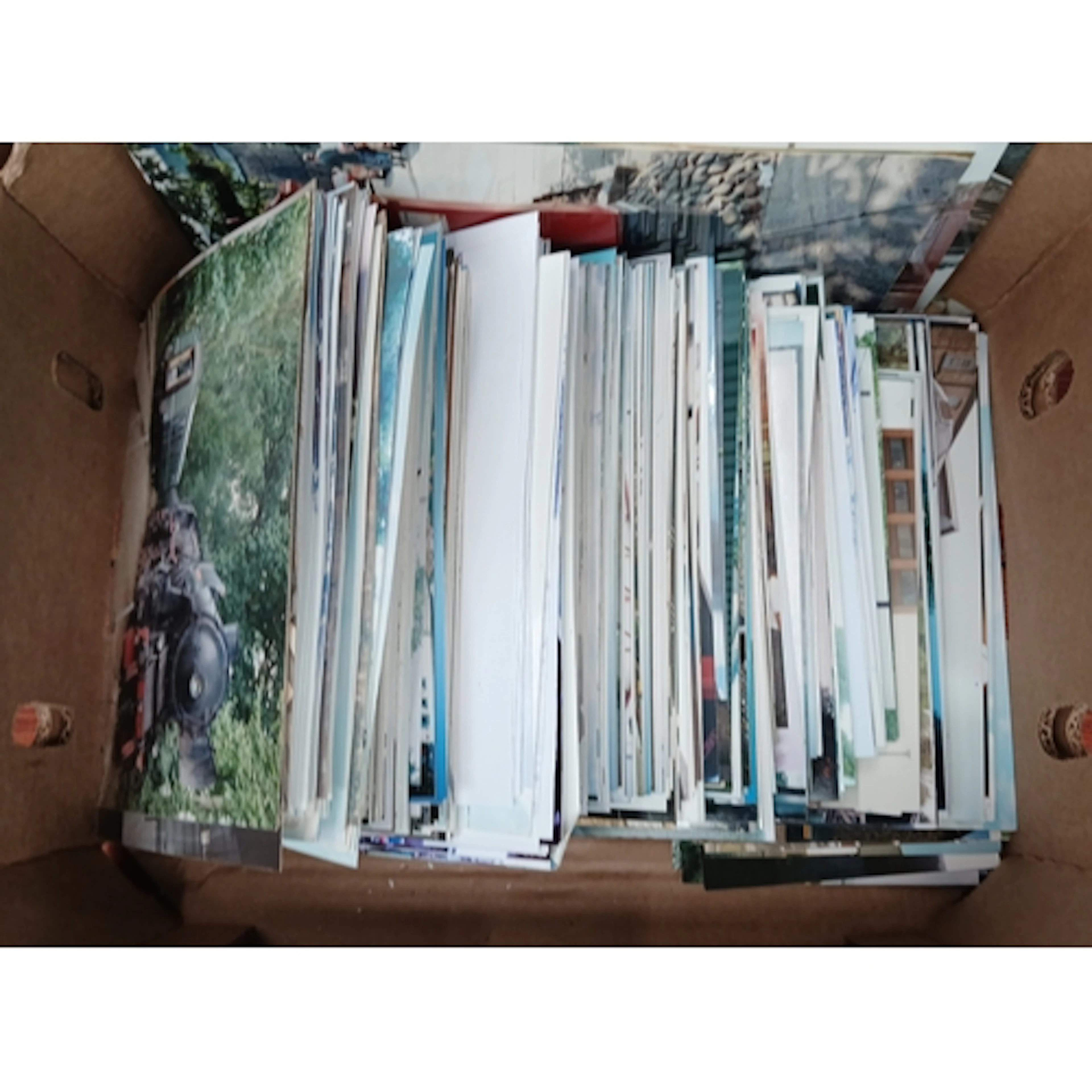 A box of assorted train photographs.