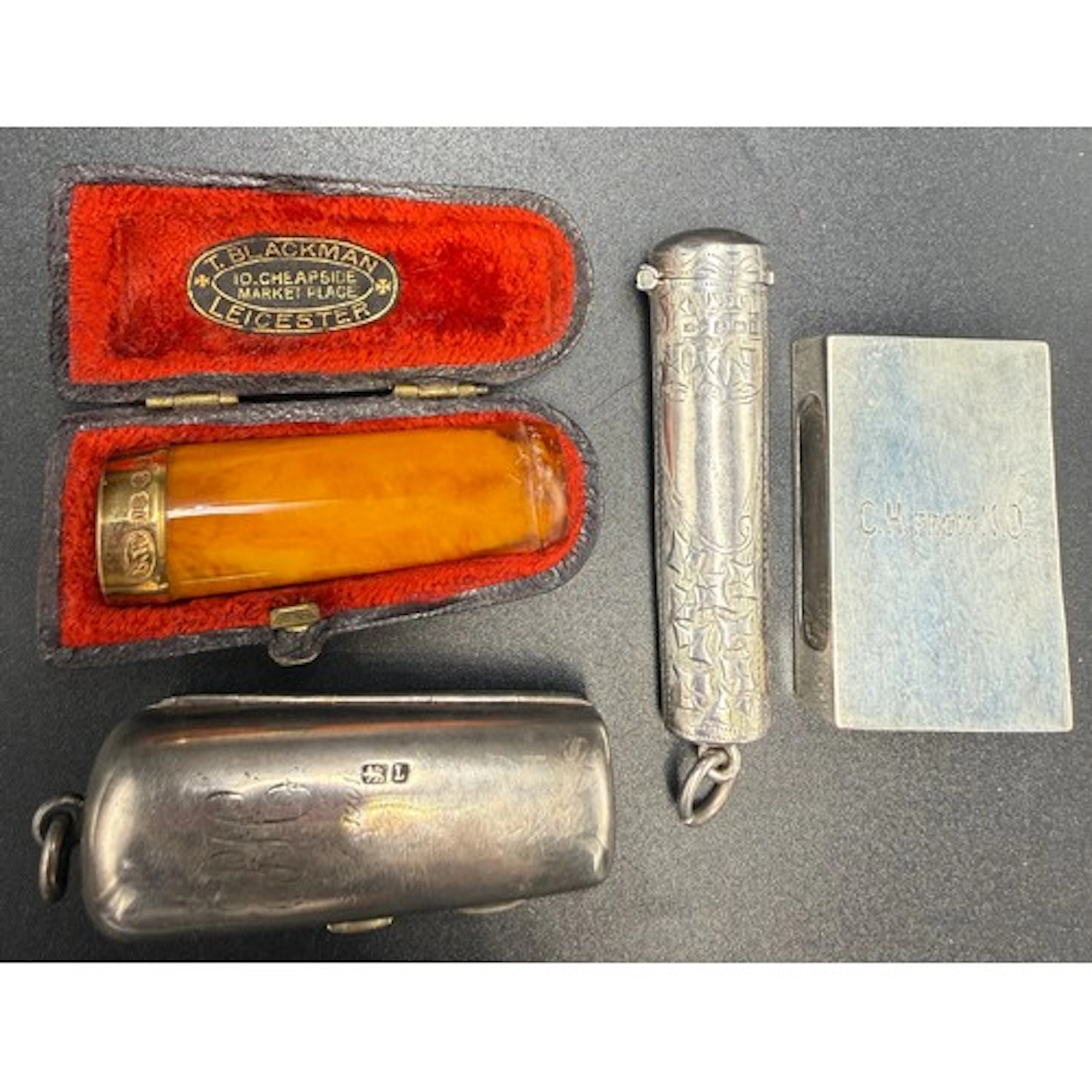 Silver match box cover and two silver cheroot holder cases t...
