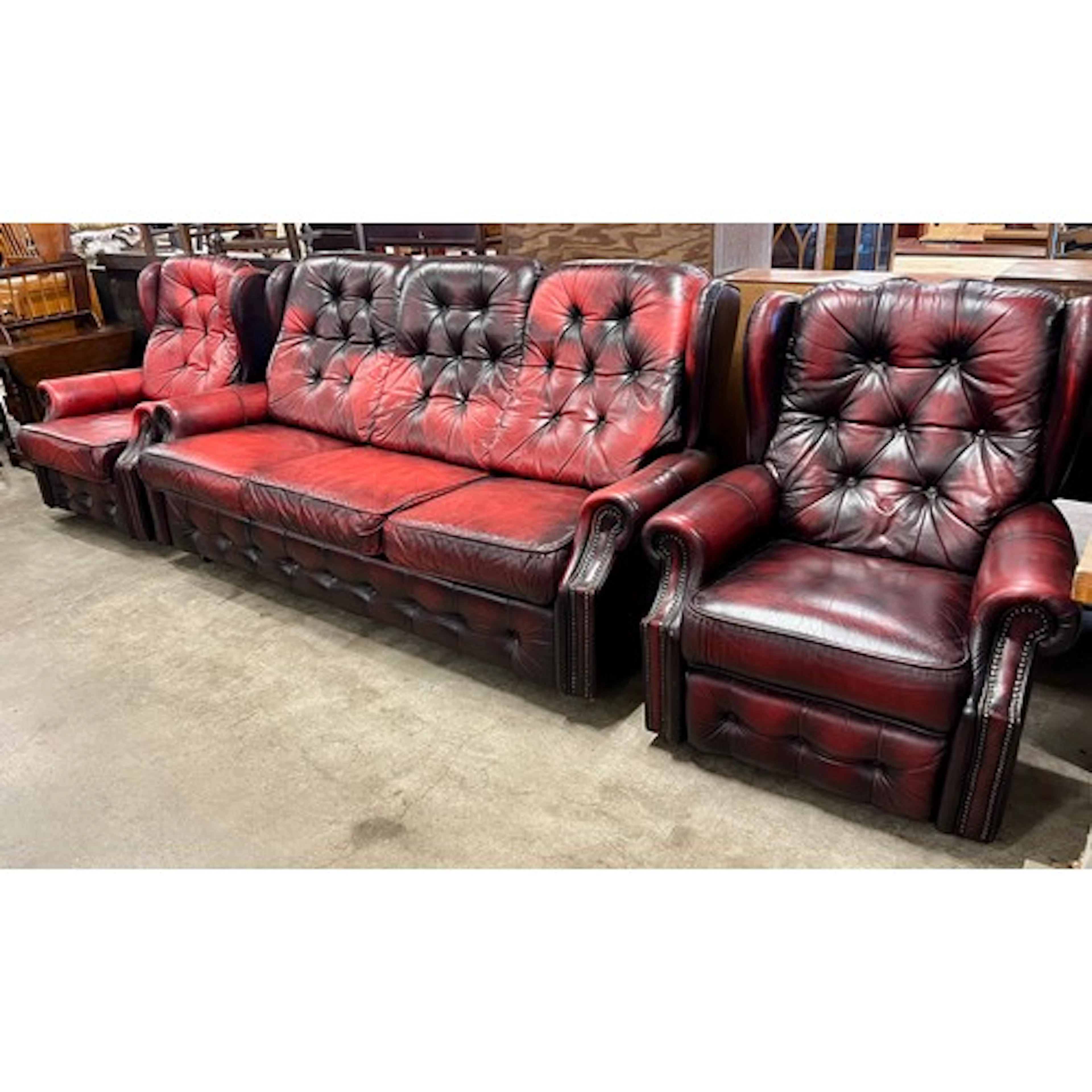 A red leather Chesterfield style settee, wingback armchair a...