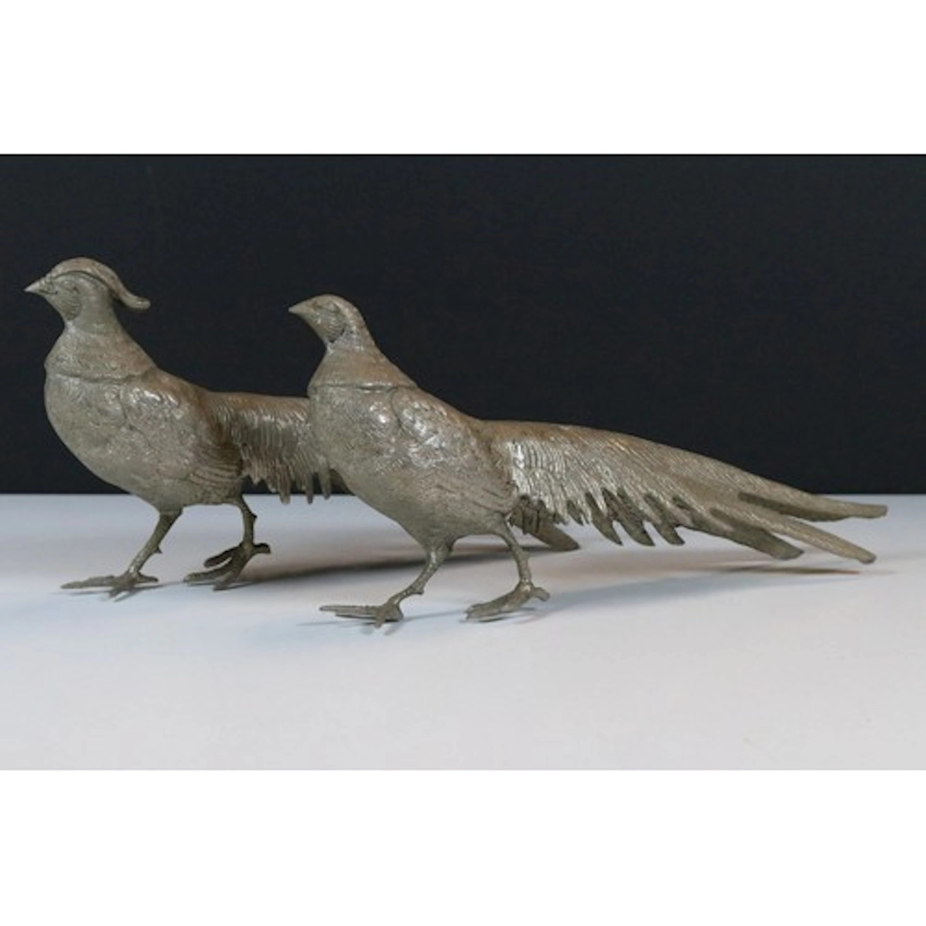 Pair of white metal pheasant figurines, tallest measures 13....
