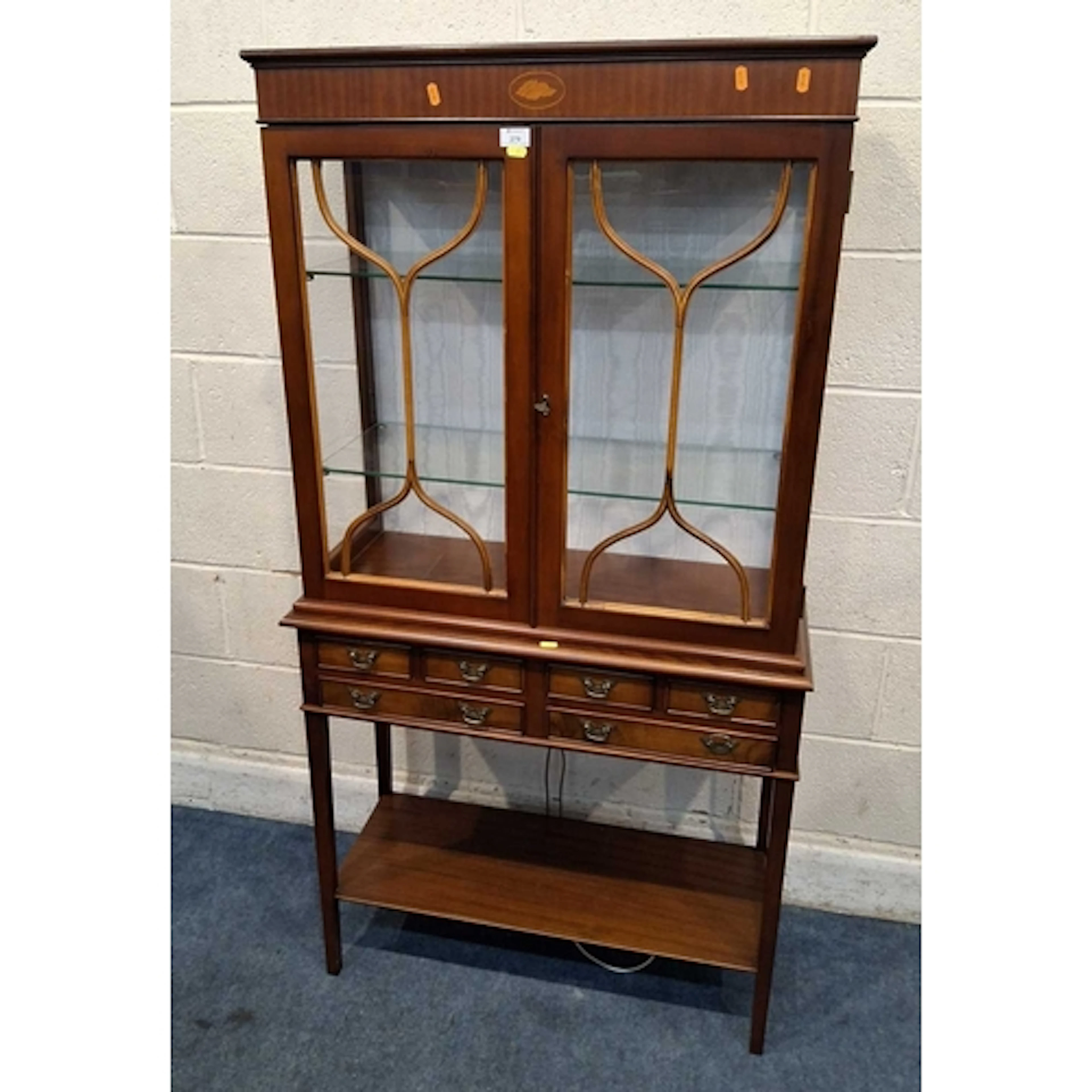 A REPRODUCTION DISPLAY CABINET, the double glass doors enclo...