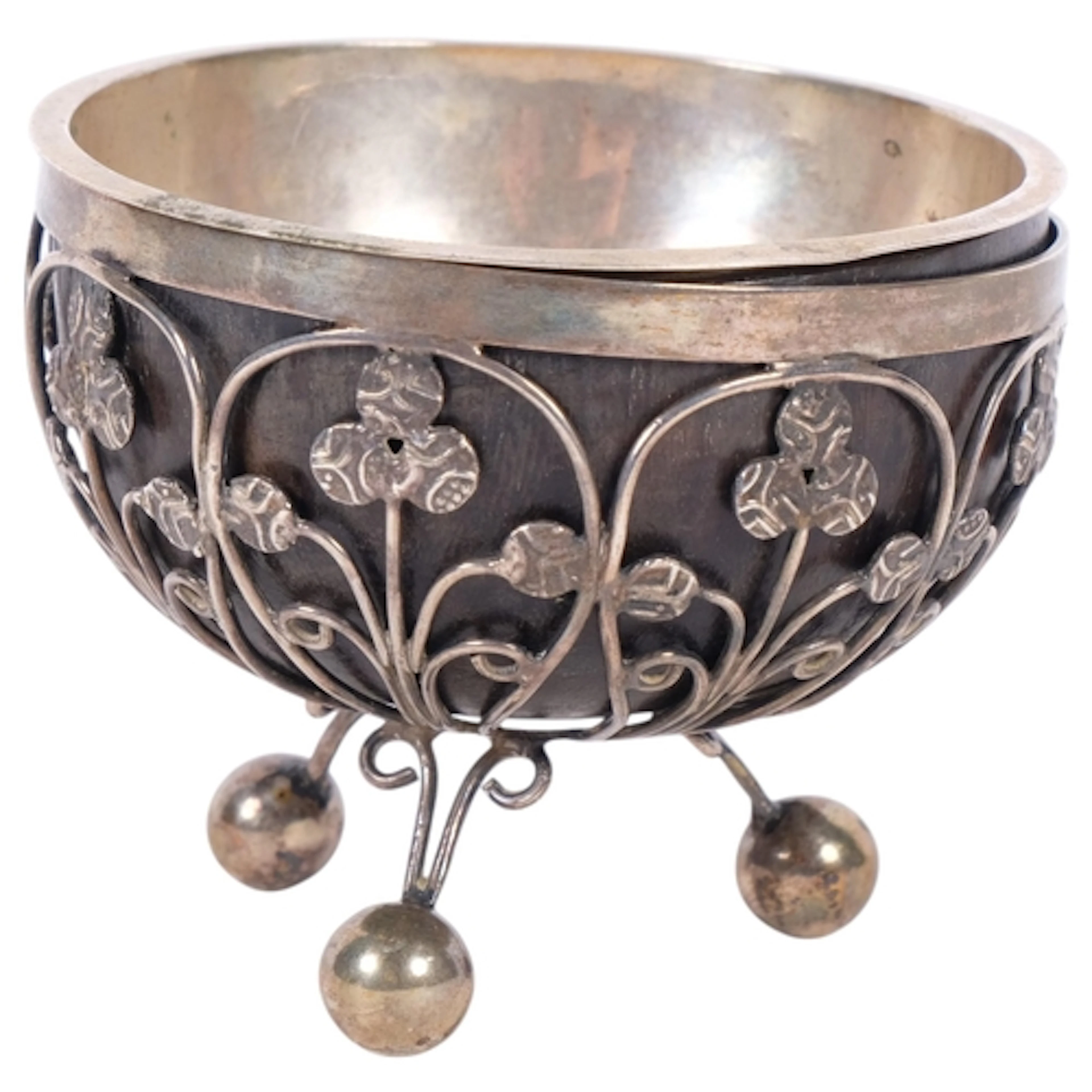An Antique table salt, a half coconut shell, with silver pla...
