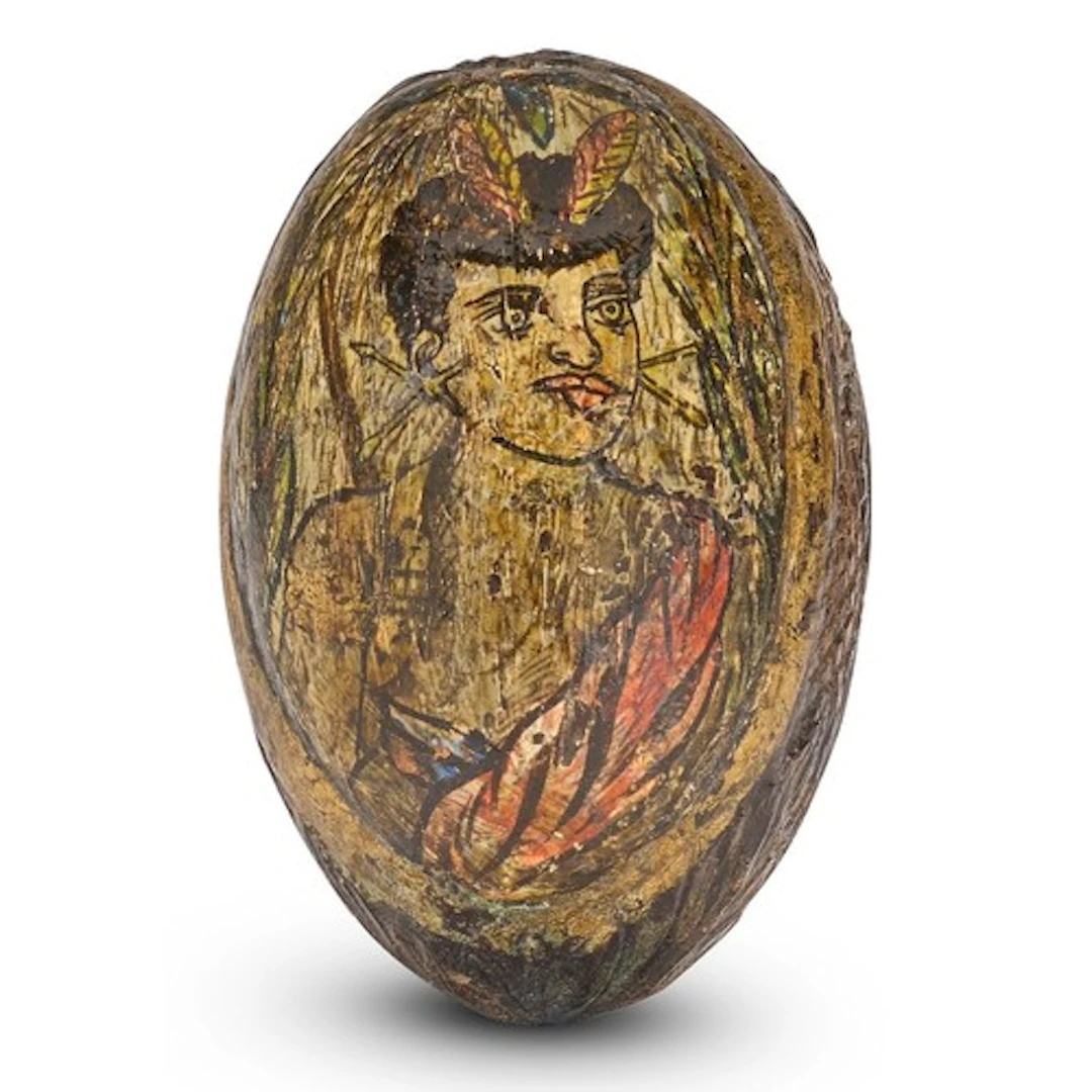 A colonial carved and polychrome painted coconut 'bugbear', ...