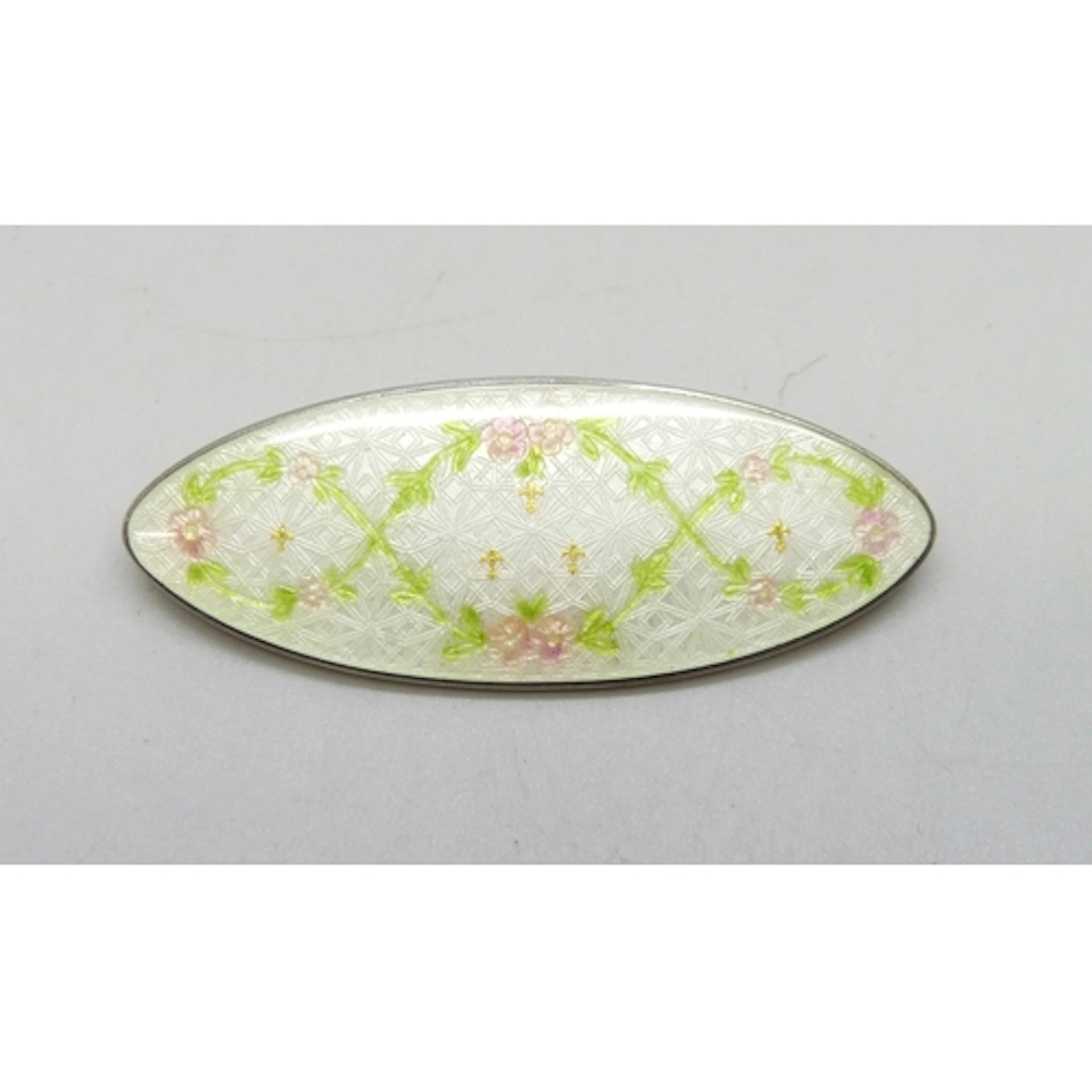 A sterling silver and guilloche enamel brooch with floral de...