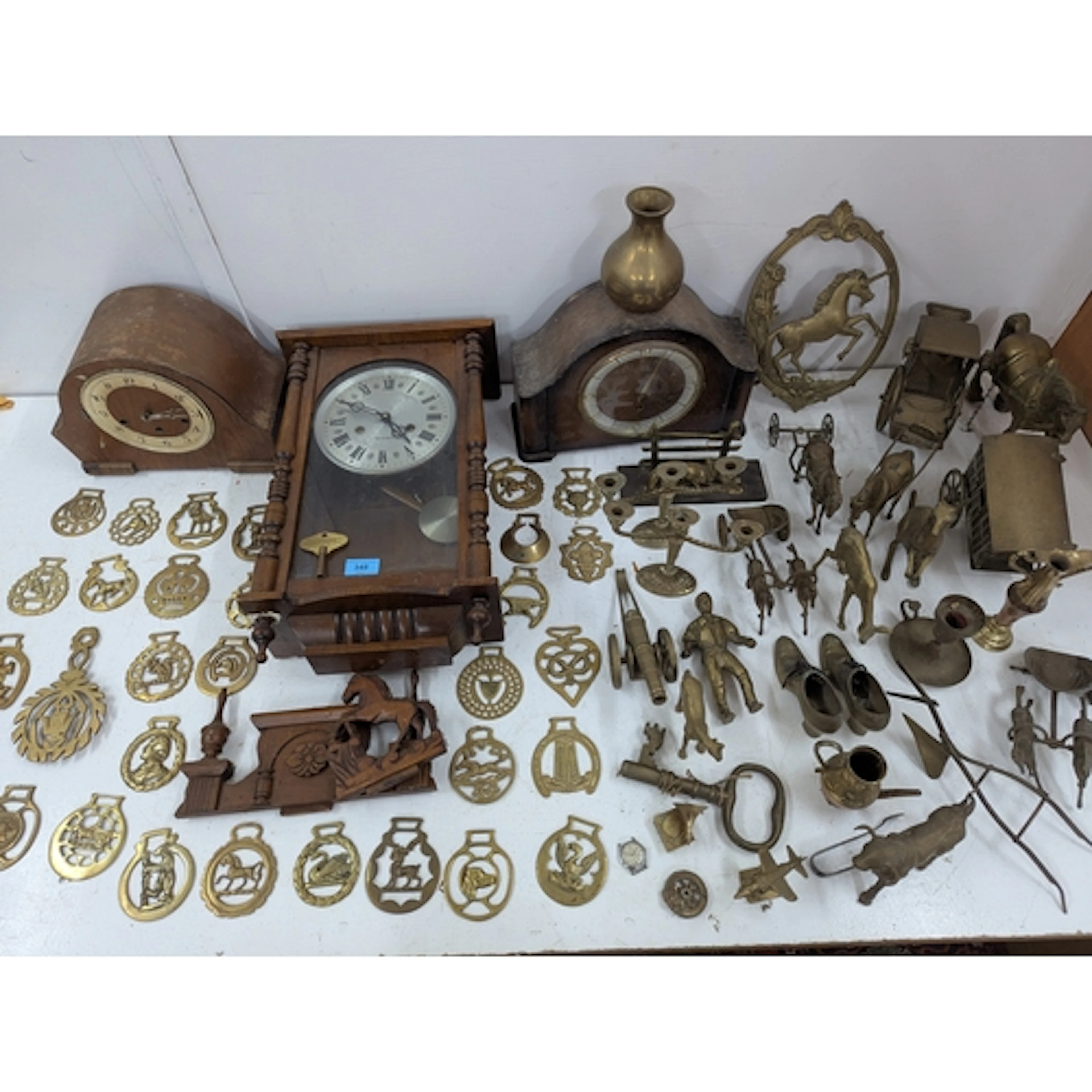 Three clocks and a large collection of horse brasses and oth...