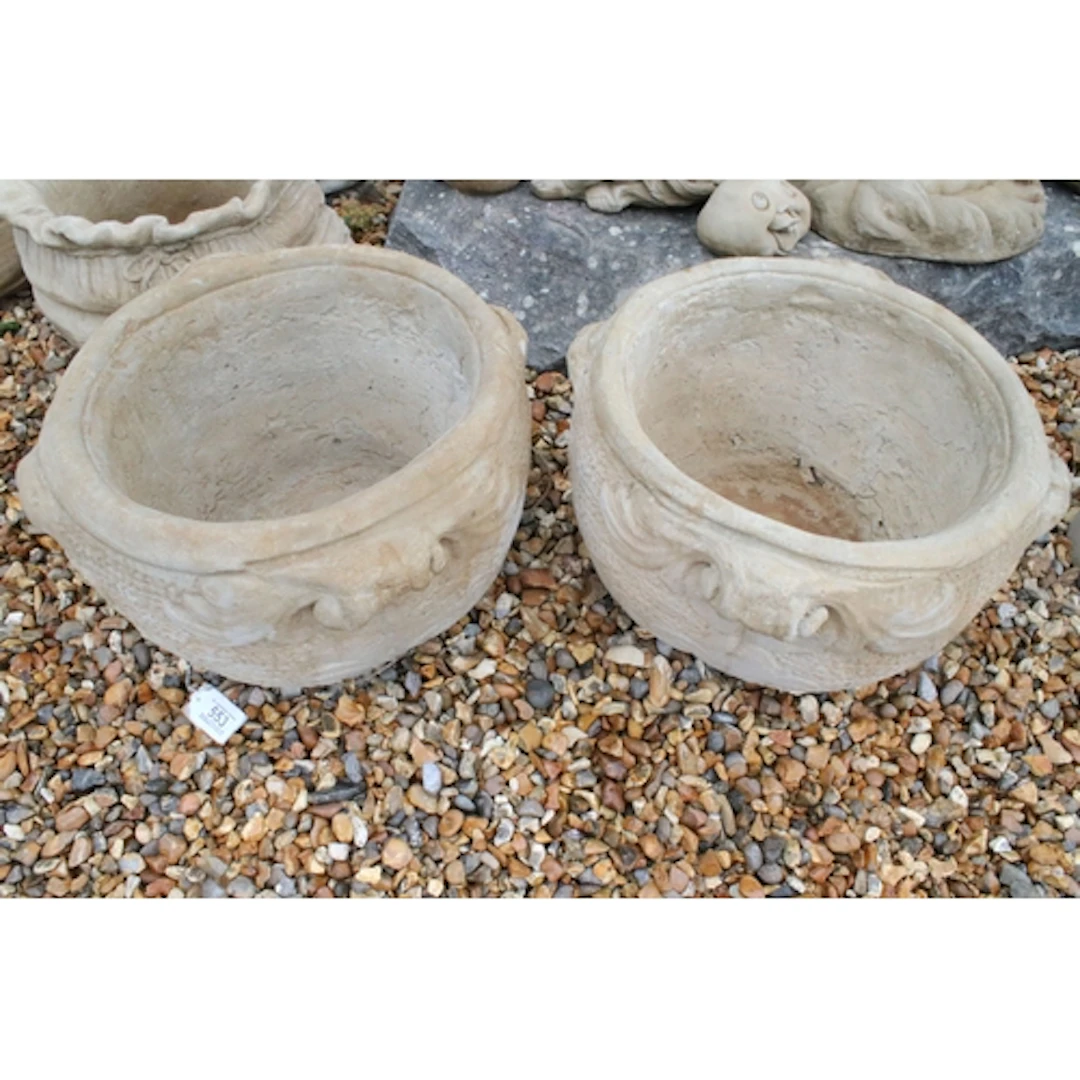 Pair of reconstituted stone garden pots, having four scrolli...