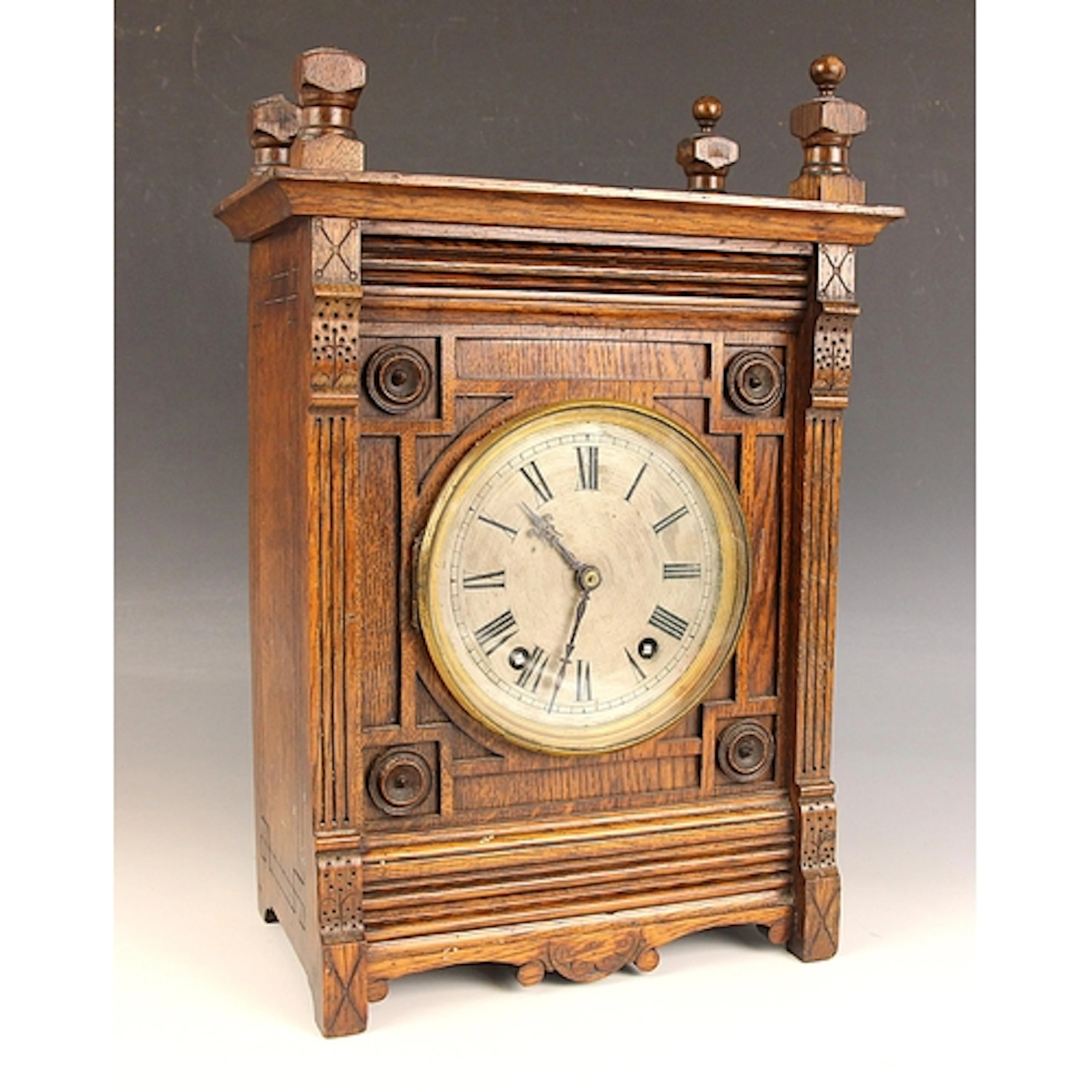An Arts & Craft oak bracket clock, the circular silvered dia...