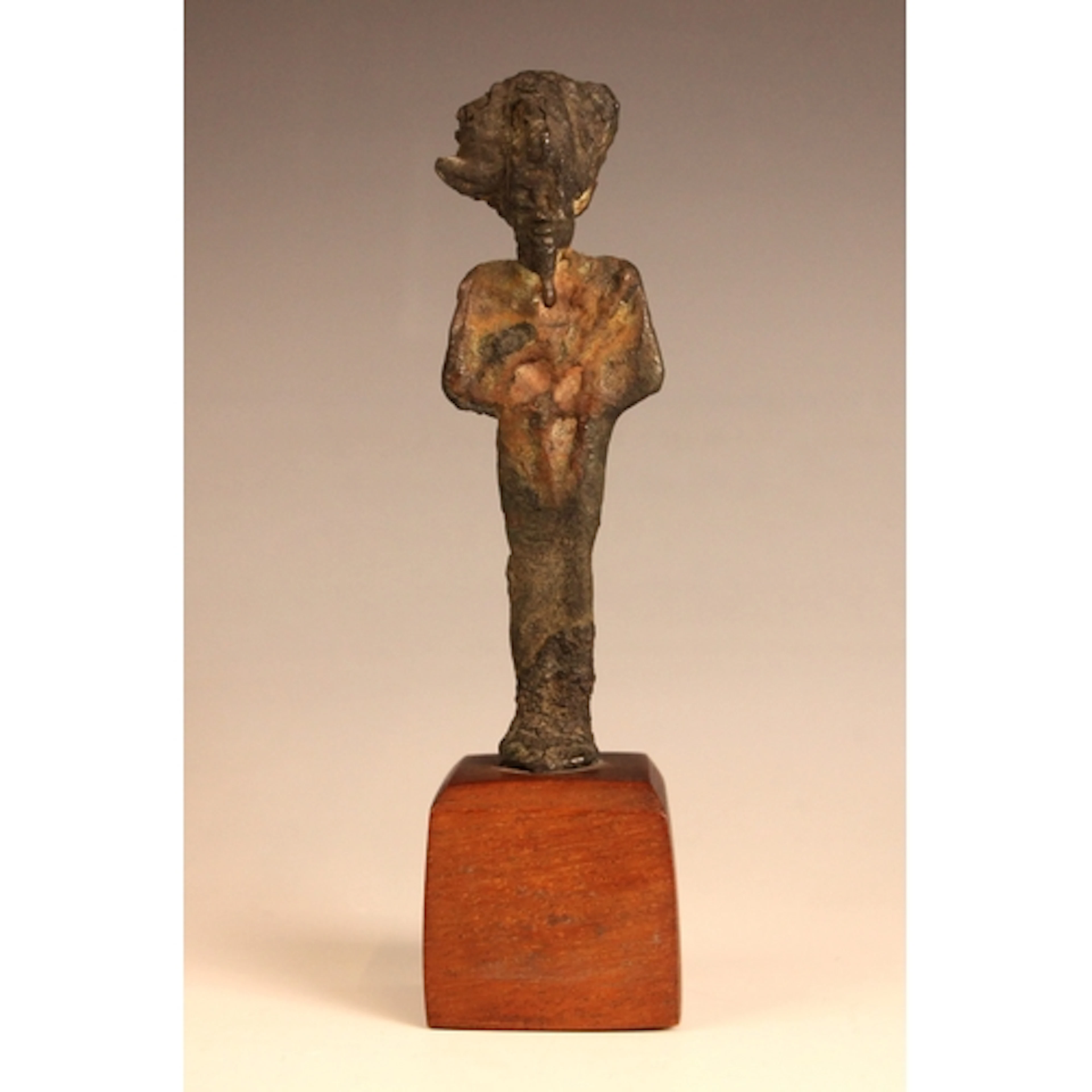 A bronze figure of the Egyptian god Osiris, modelled in mumm...