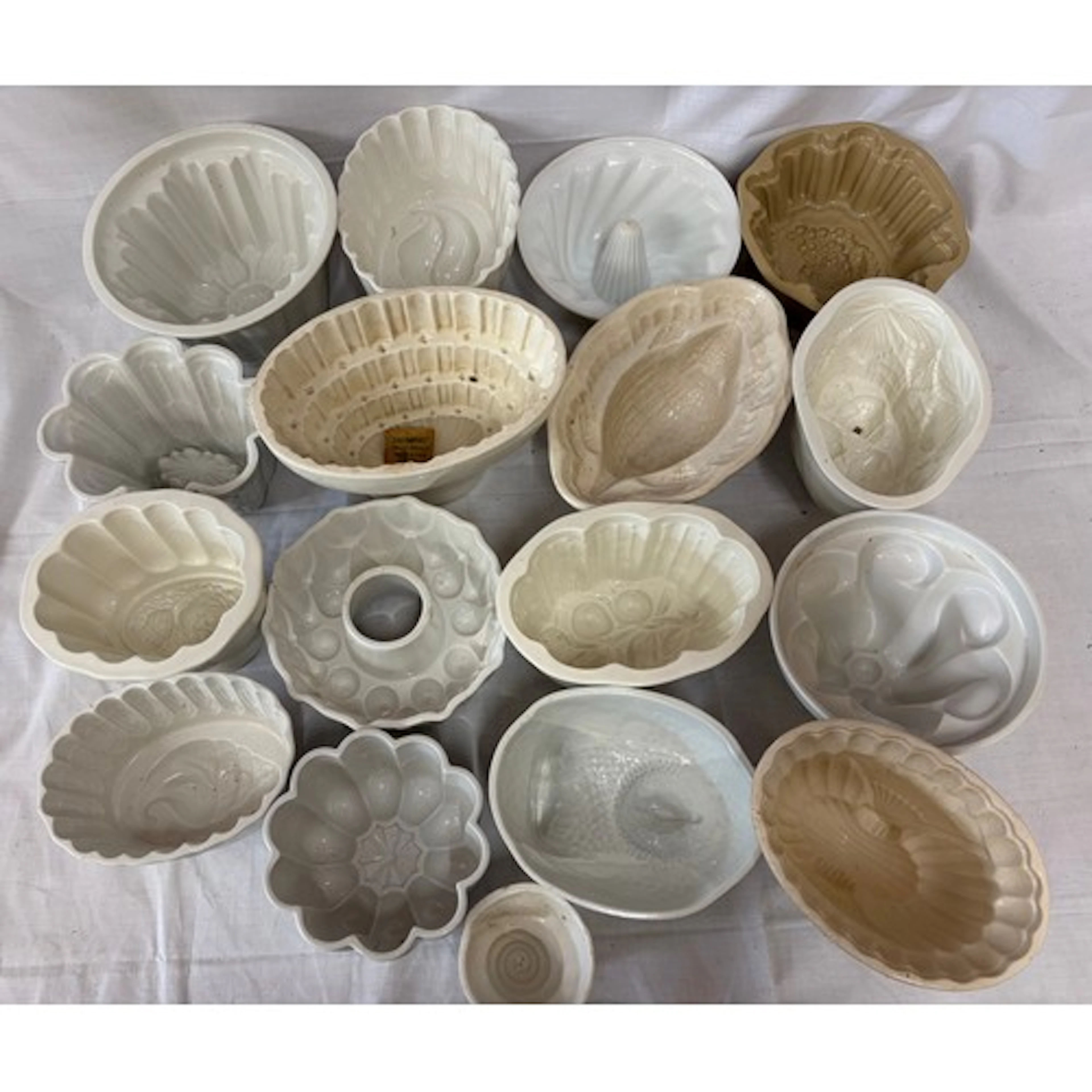 A collection of ceramic and stone jelly moulds to include: D...