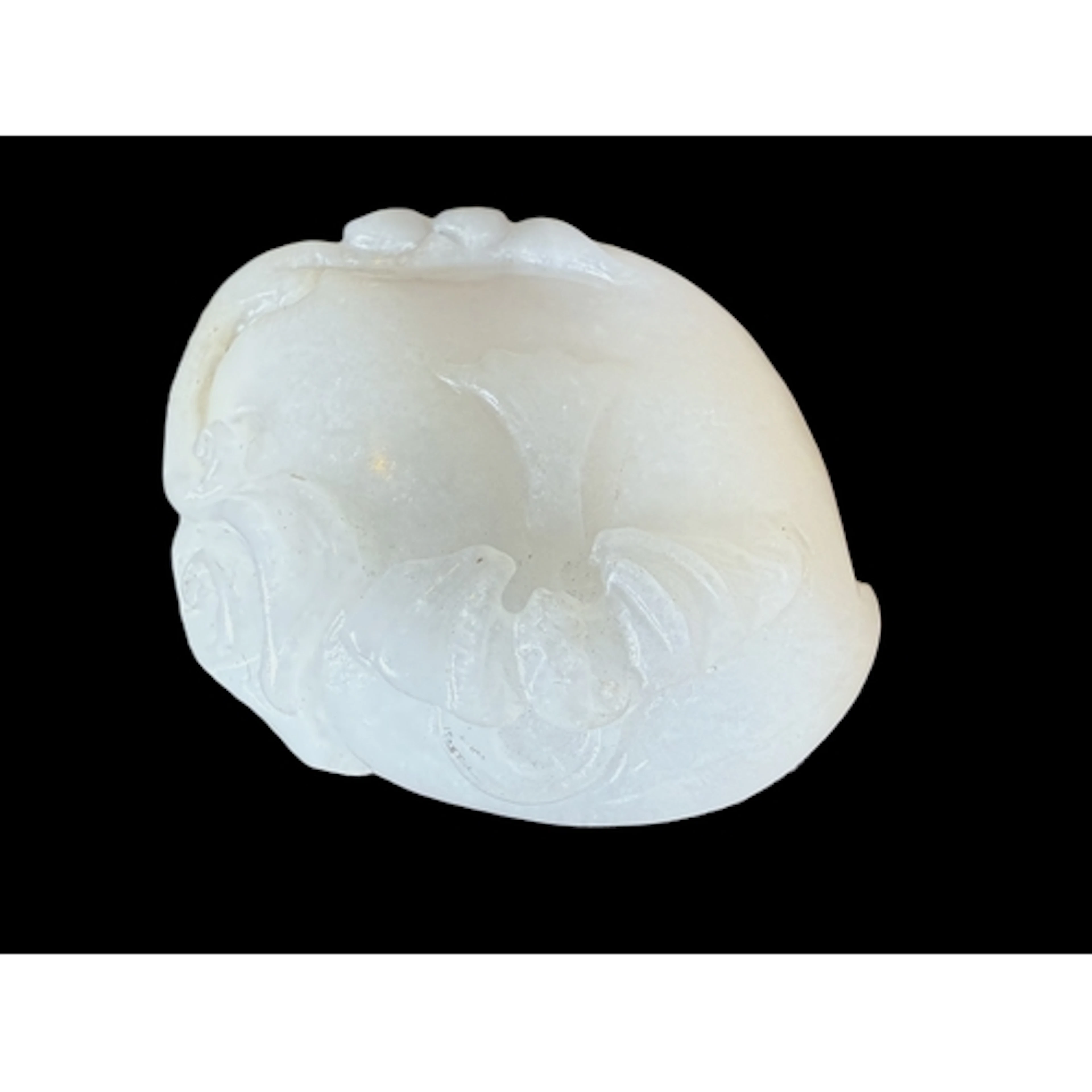A Chinese pale celadon jade carved pebble, on hardwood stand...