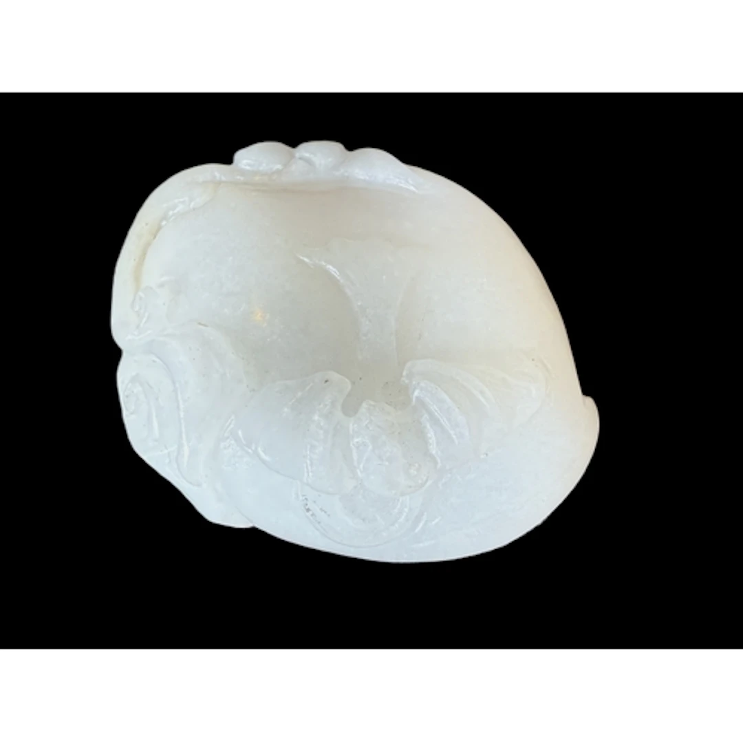 A Chinese pale celadon jade carved pebble, on hardwood stand...