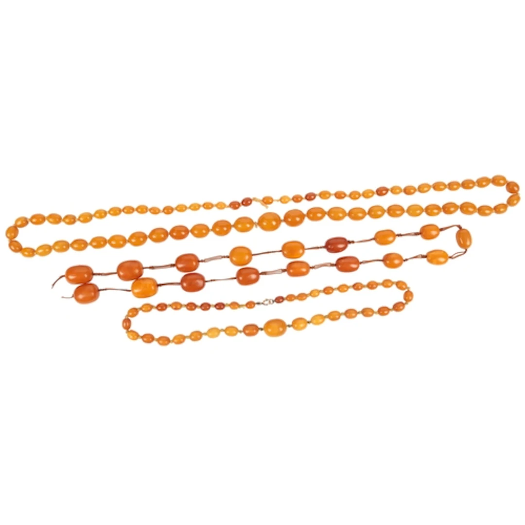 Three amber necklaces, early 20th century, two composed of g...