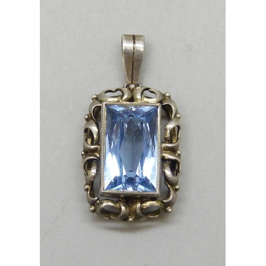 An Art Deco Continental .830 silver and topaz necklace penda...