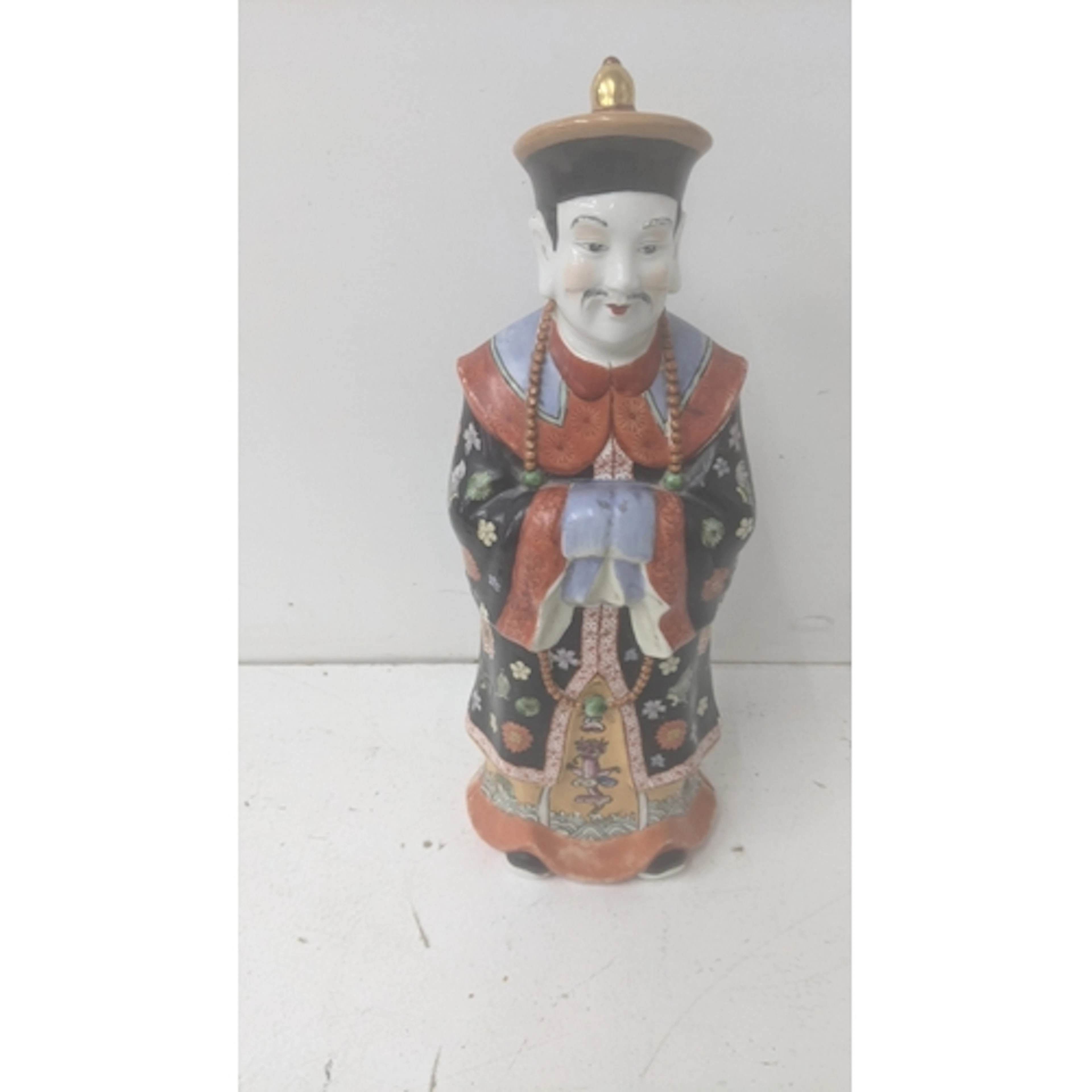A vintage Chinese Qing dynasty porcelain figure depicting an...