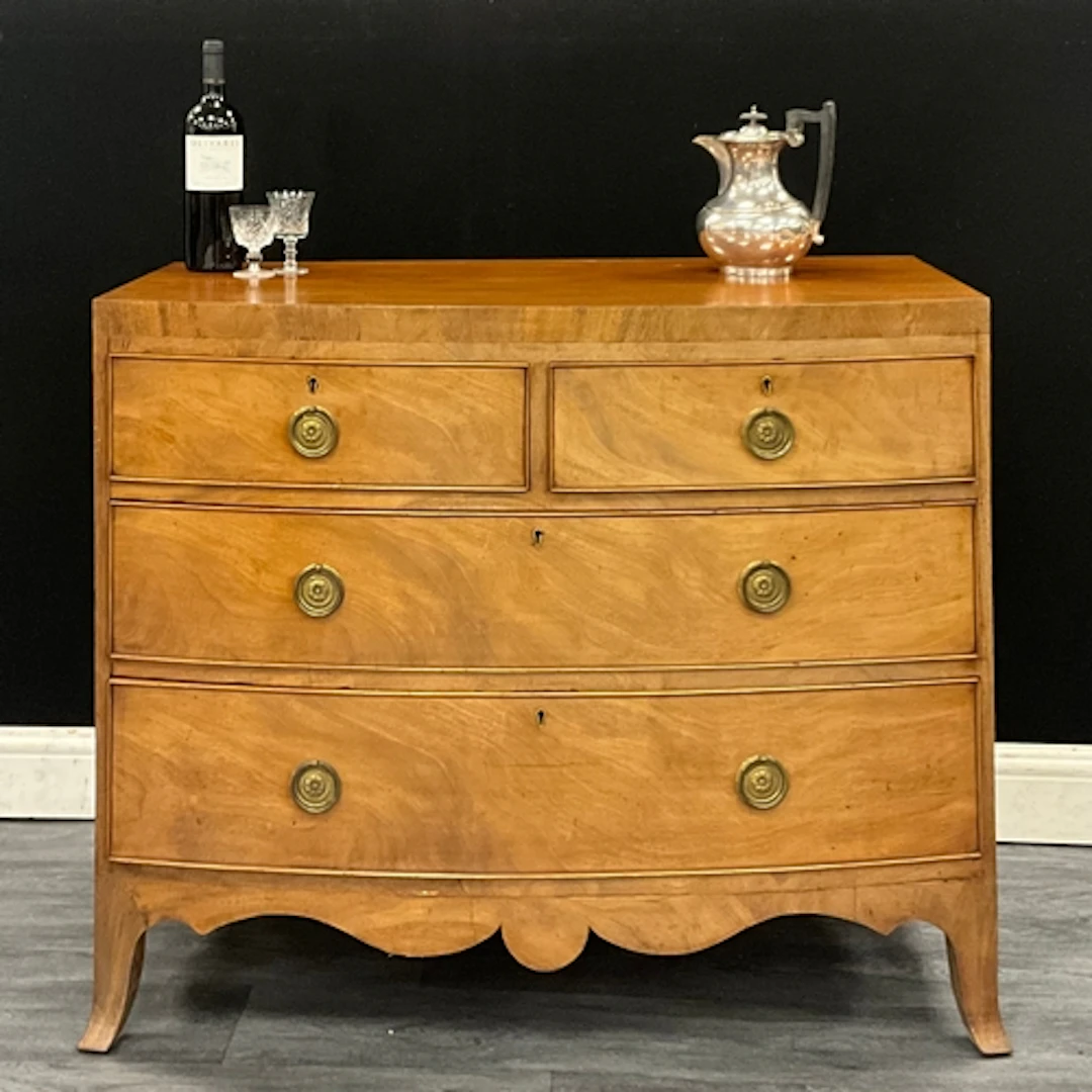 A George lll mahogany bow front chest of drawers, two short ...