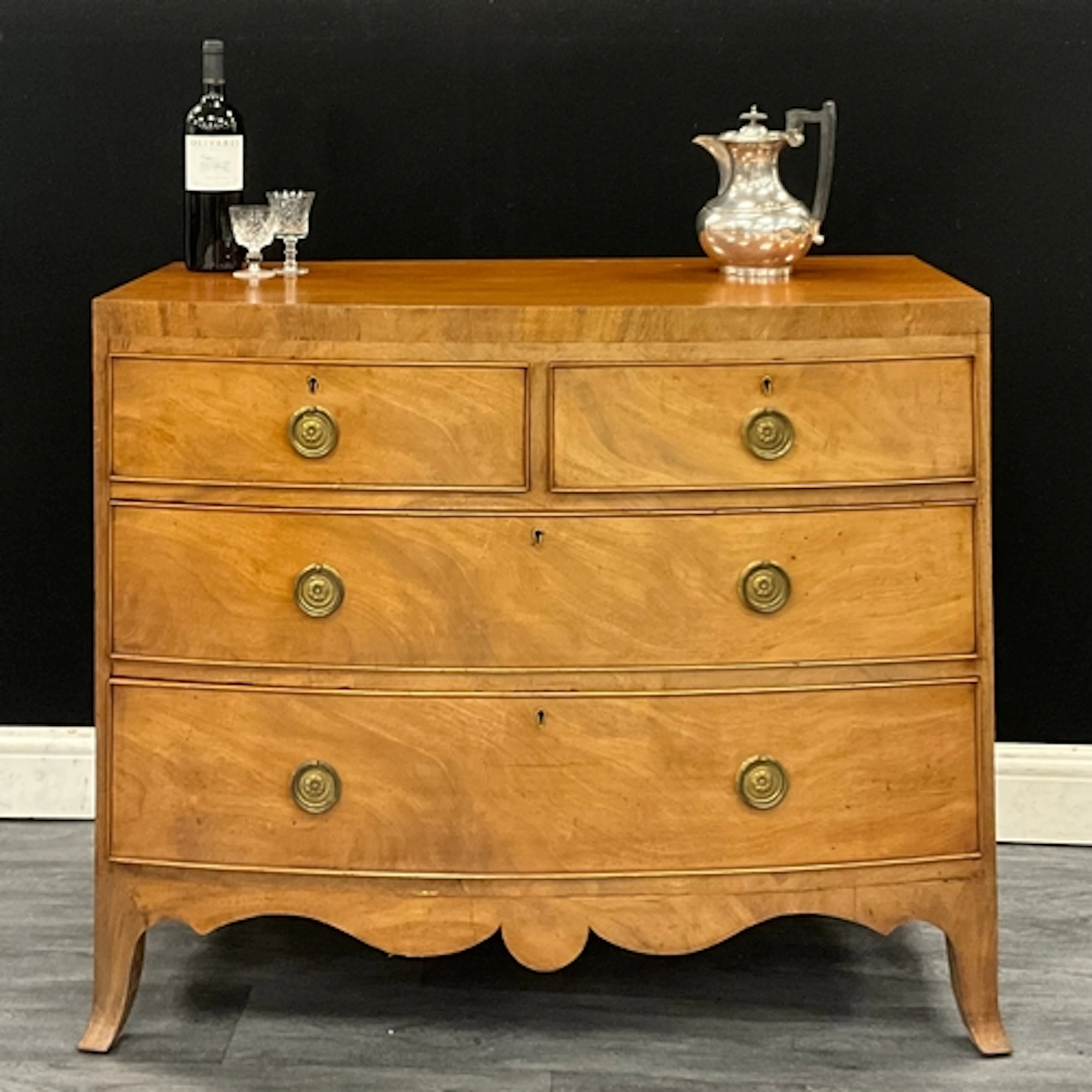 A George lll mahogany bow front chest of drawers, two short ...