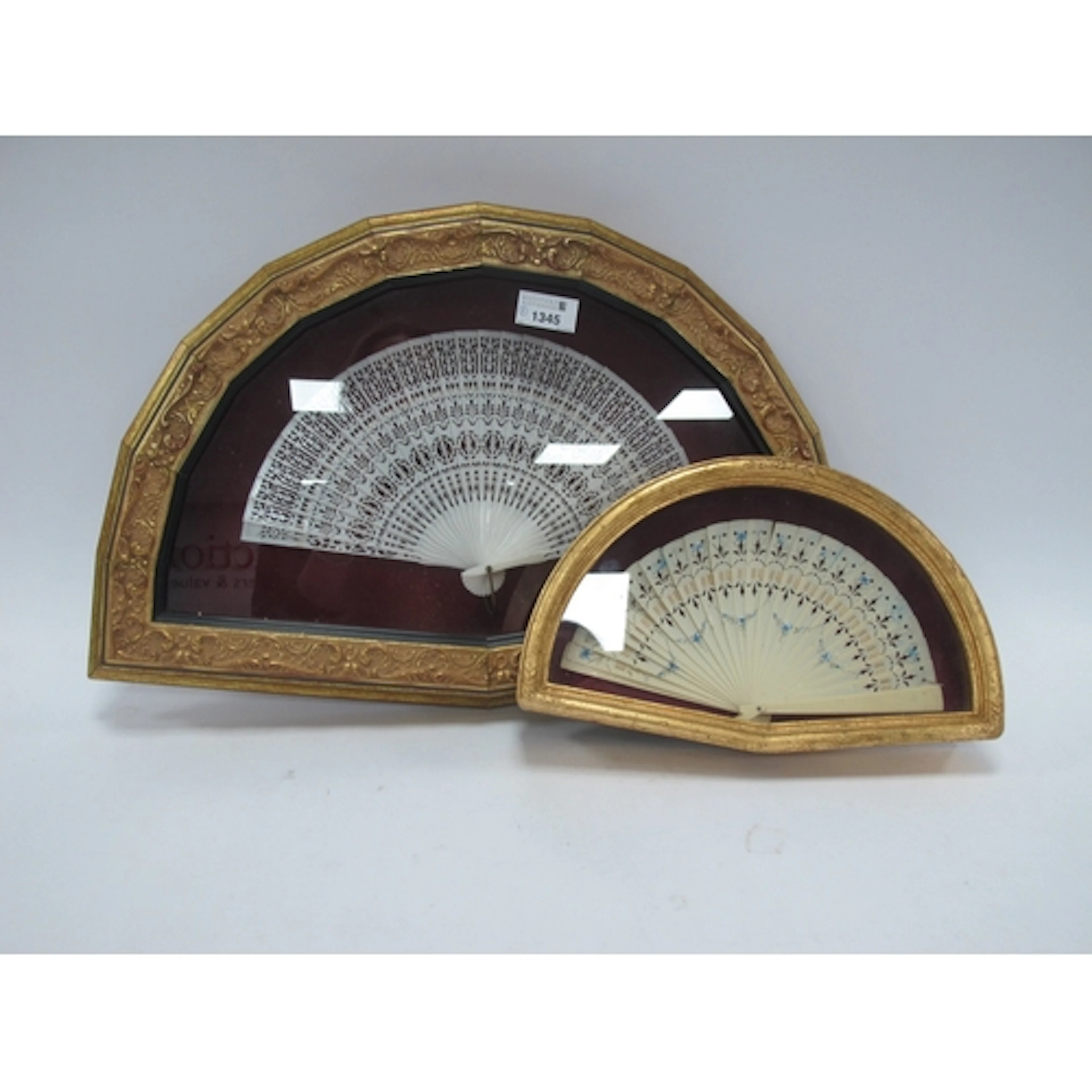 Two early 20th century folding fans, one pierced and painted...