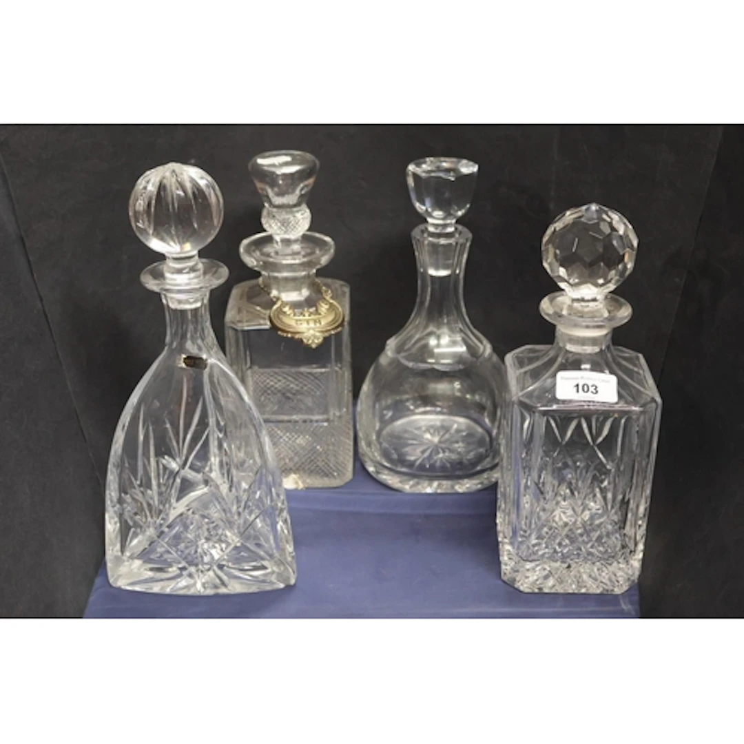 Four decanters and a gin label.
