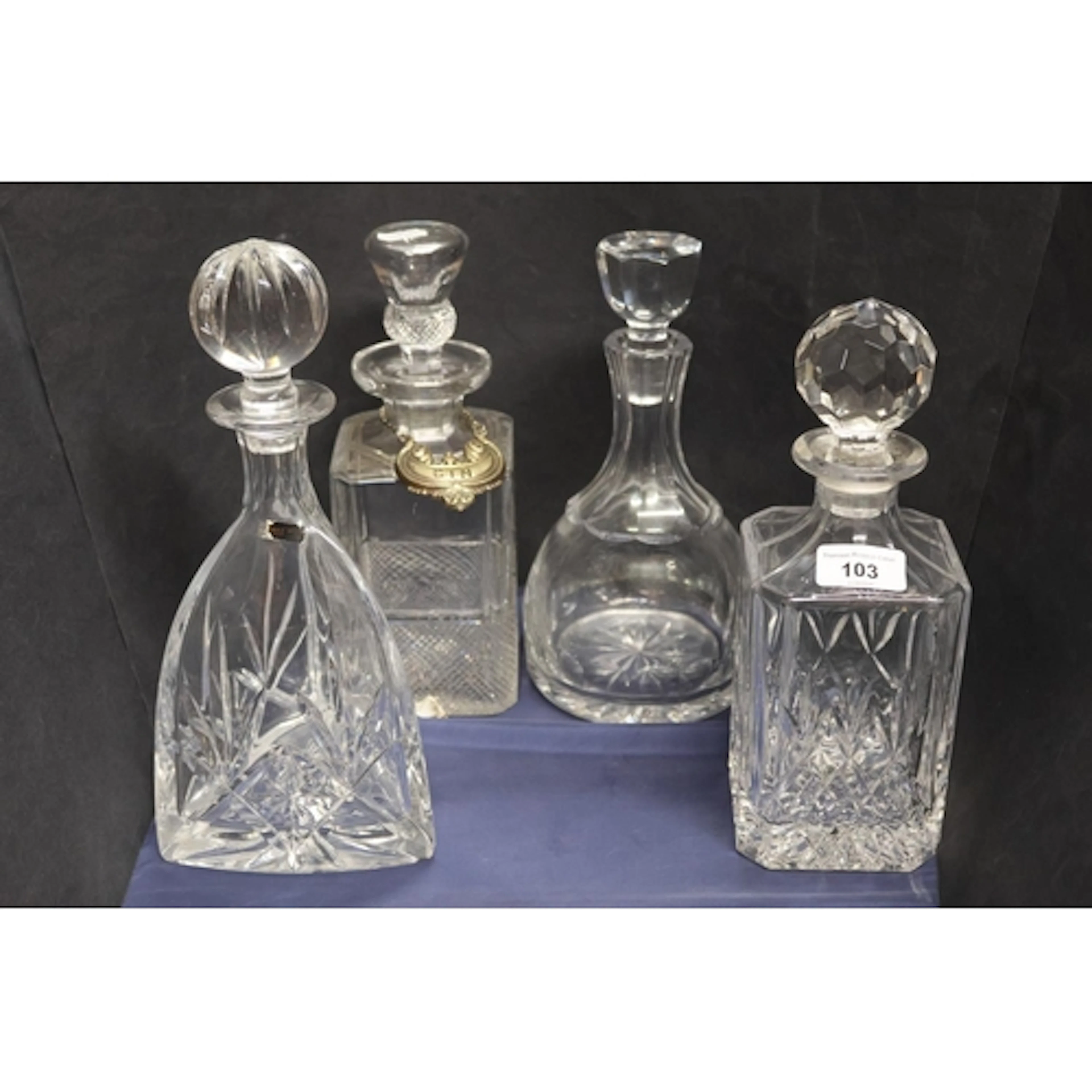 Four decanters and a gin label.