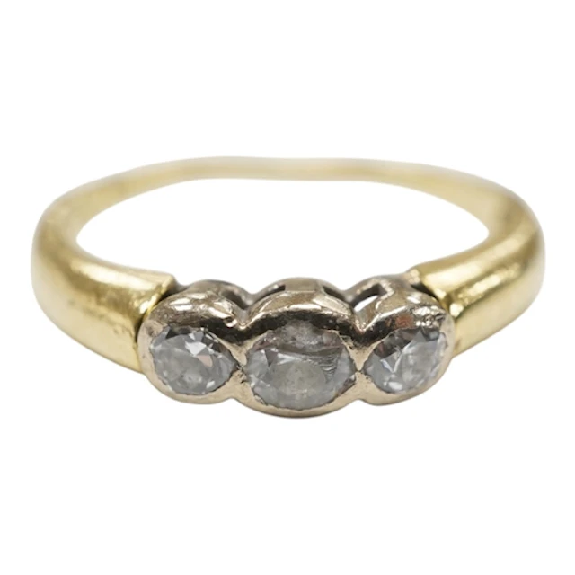 A recent 18ct gold and three stone diamond ring, size N, gro...