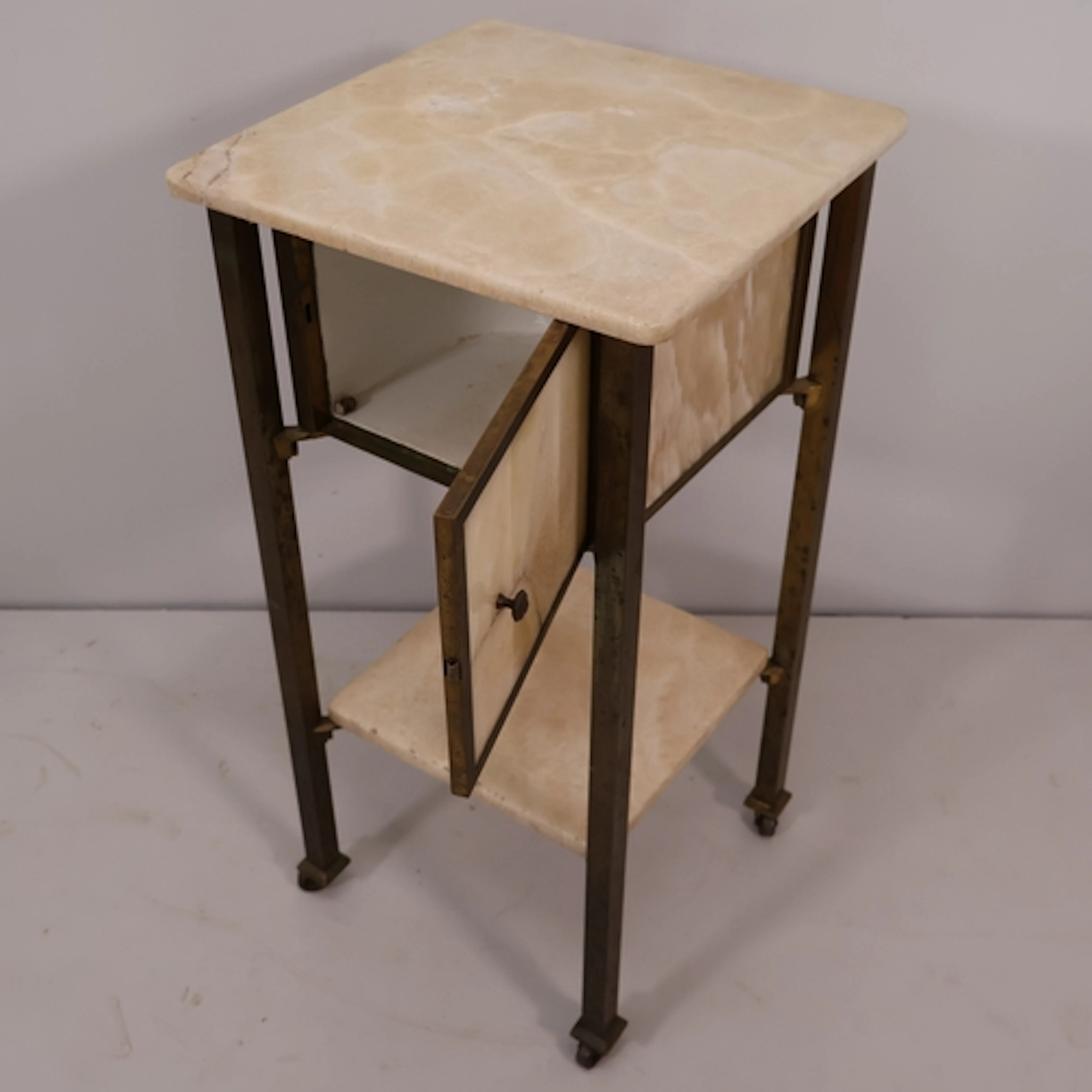A Hollywood regency style onyx and brass framed night stand,...