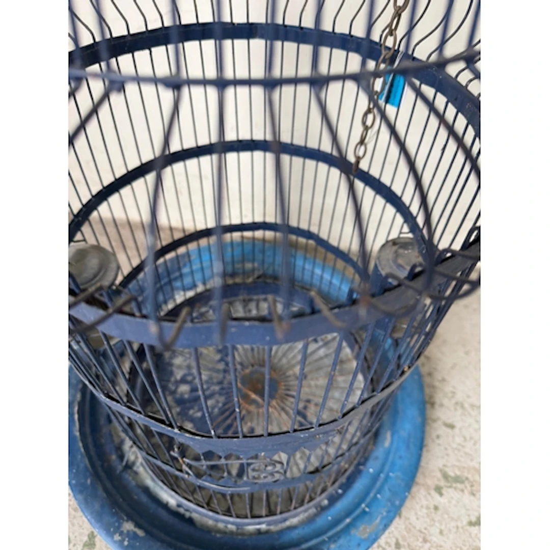 A blue painted dome topped birdcage