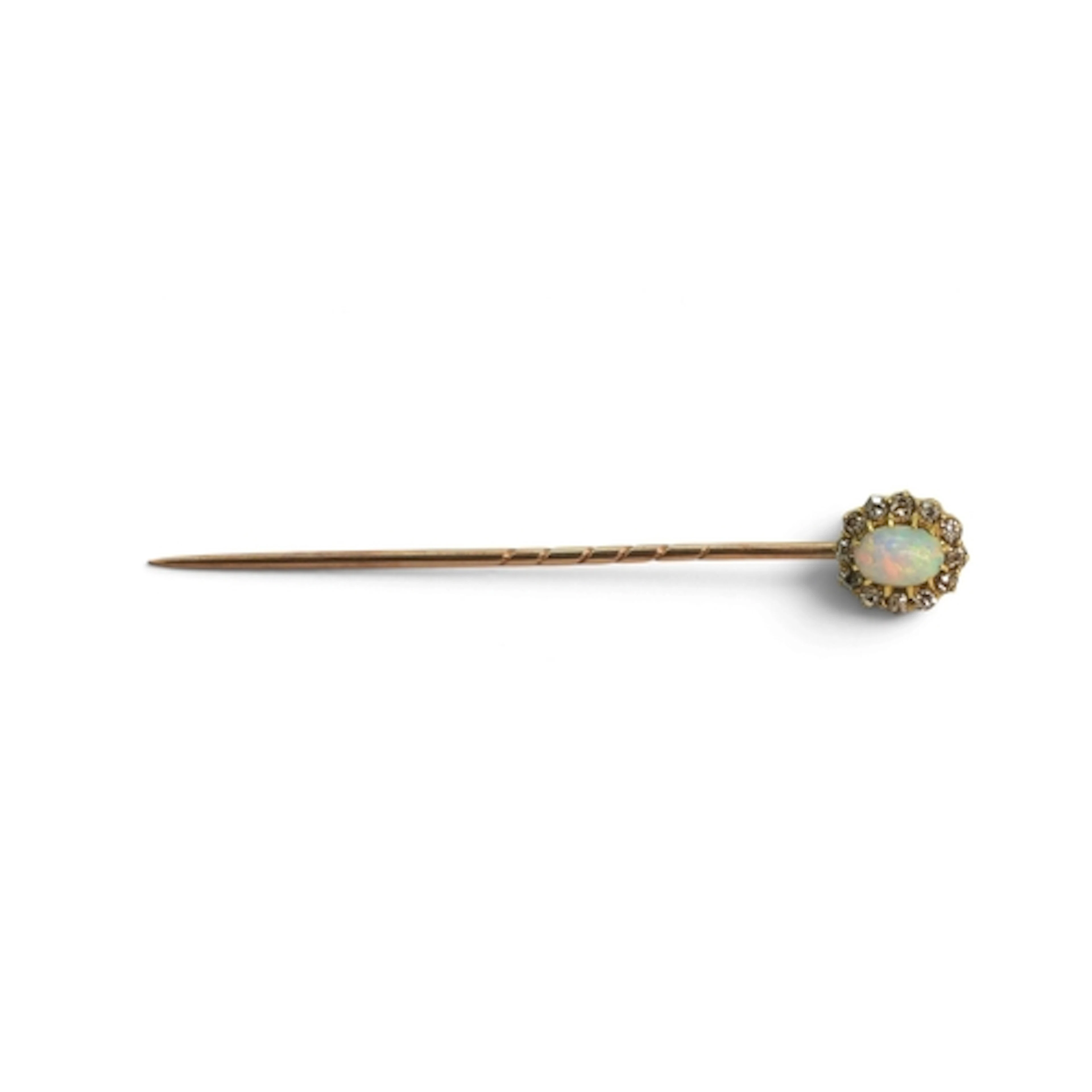 A yellow metal lapel pin set with a good colourful opal and ...