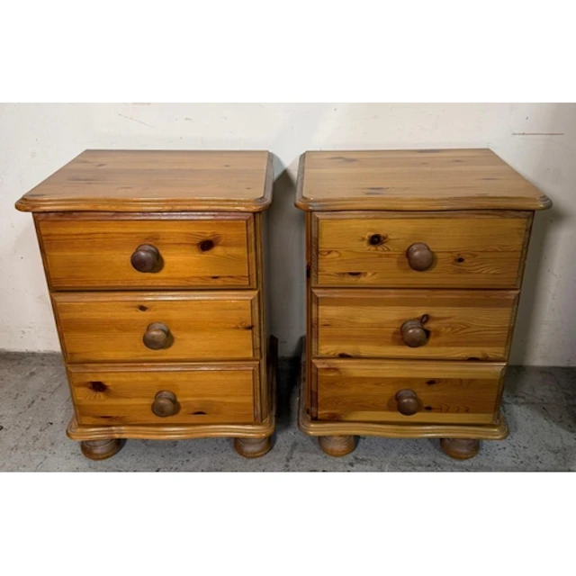 A pair of pine bedsides comprising of three drawers